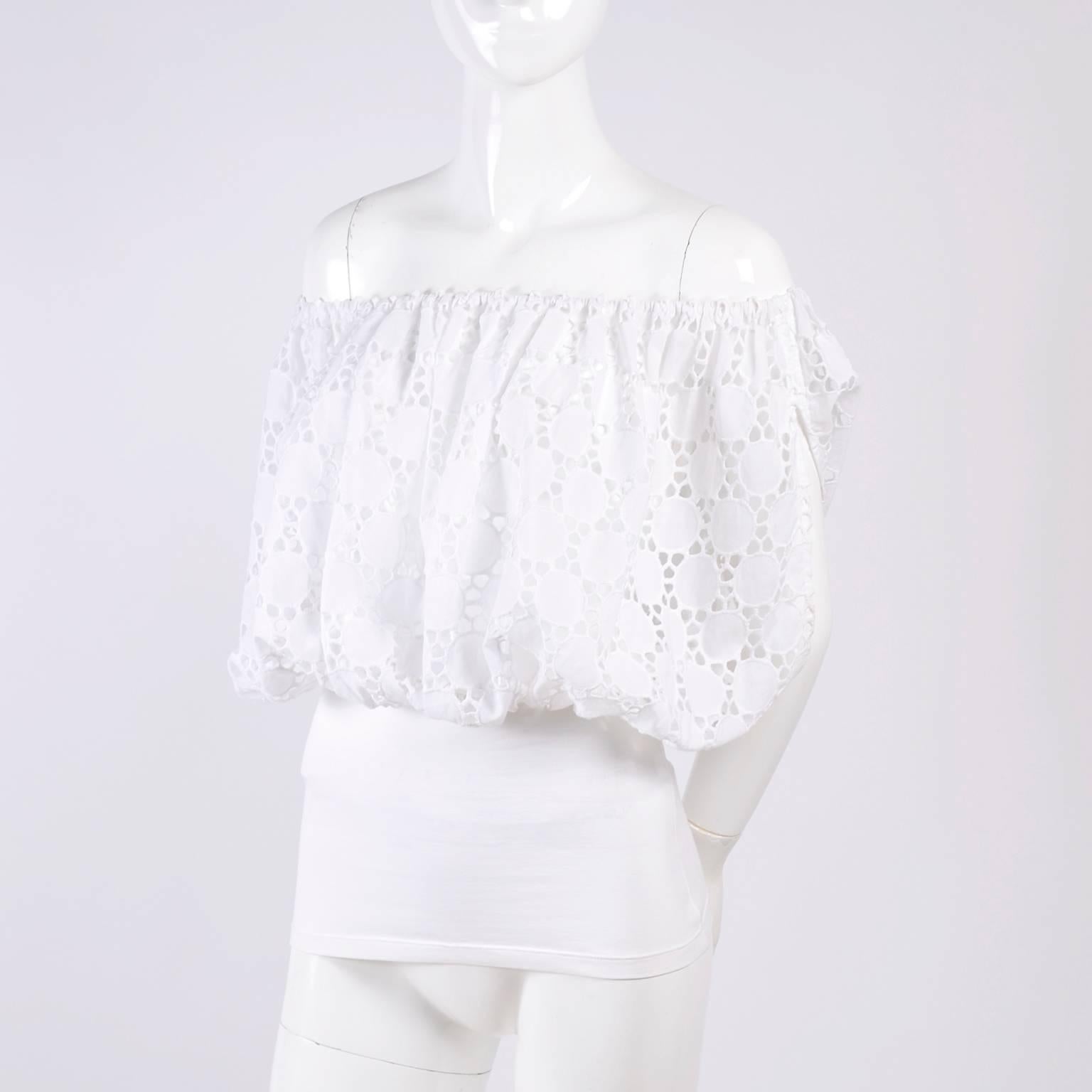 This is a fabulous white cotton Anne Fontaine Blouse with an eyelet cutwork top portion and a stretch knit fitted waist with the original Anne Fontaine tag attached.  This gorgeous top would be the perfect addition to your summer wardrobe, it can be