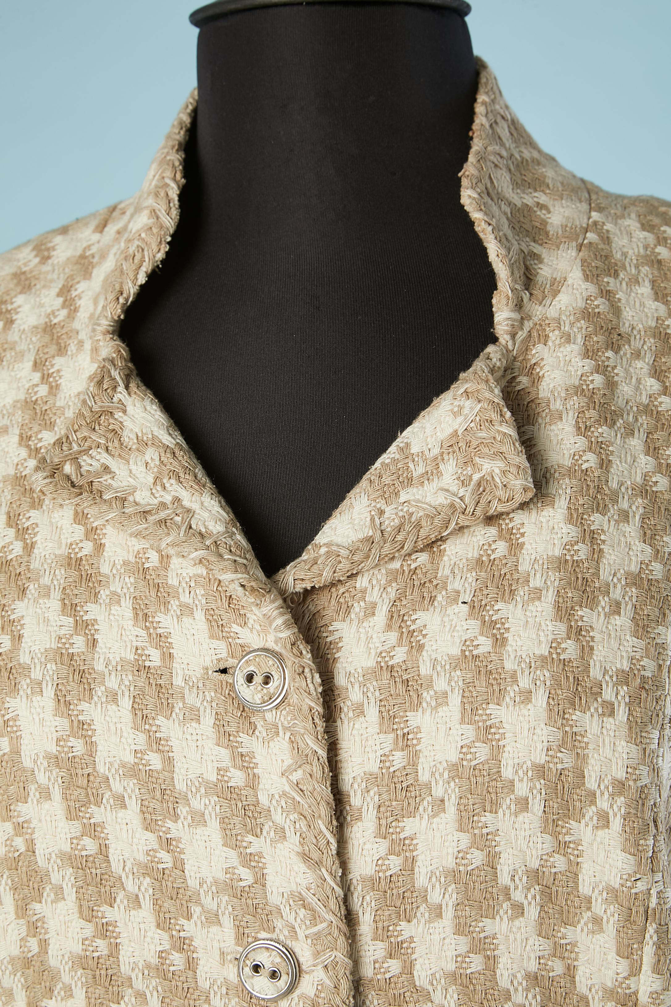 Off-white and beige silk tweed single breasted jacket. Silk branded beige lining. 
Tweed and metal branded buttons. Silver metal chain inside in the bottom edge. Half belt. Raglan sleeves. Thin shoulder pad. 
SIZE 44 (Fr) 14 (US) L 