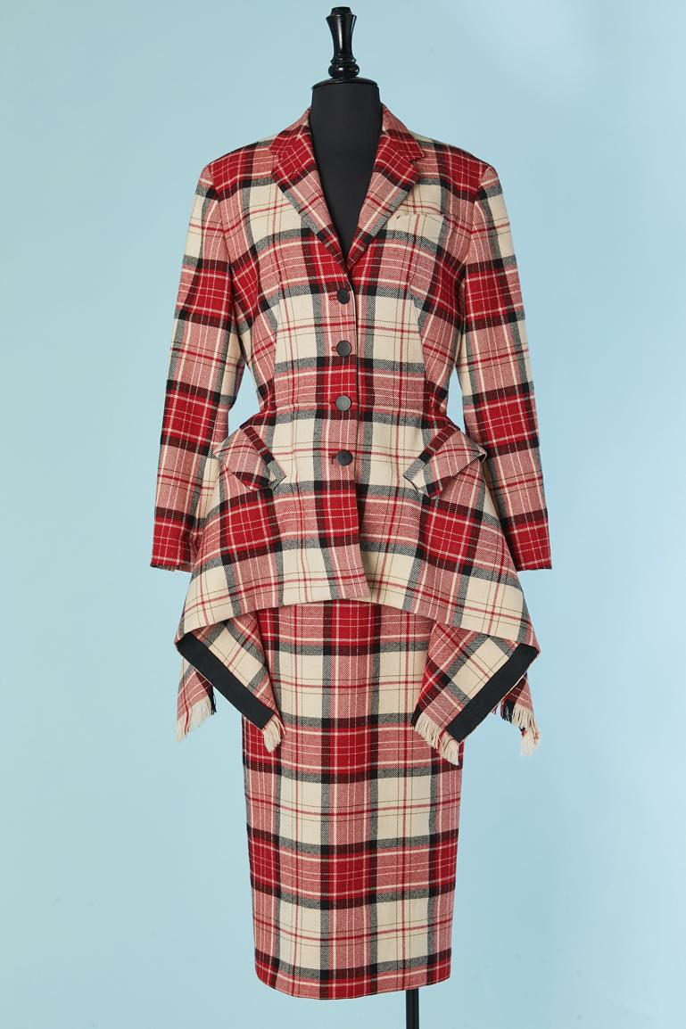 Off-white and red Tartan skirt-suit with asymmetrical jacket.
Main fabric composition: 100% wool. Lining composition: 56% cotton, 44% rayon. Button and buttonhole closure on the middle front. Cut-work. Pocket on both side . 
Total lenght middle