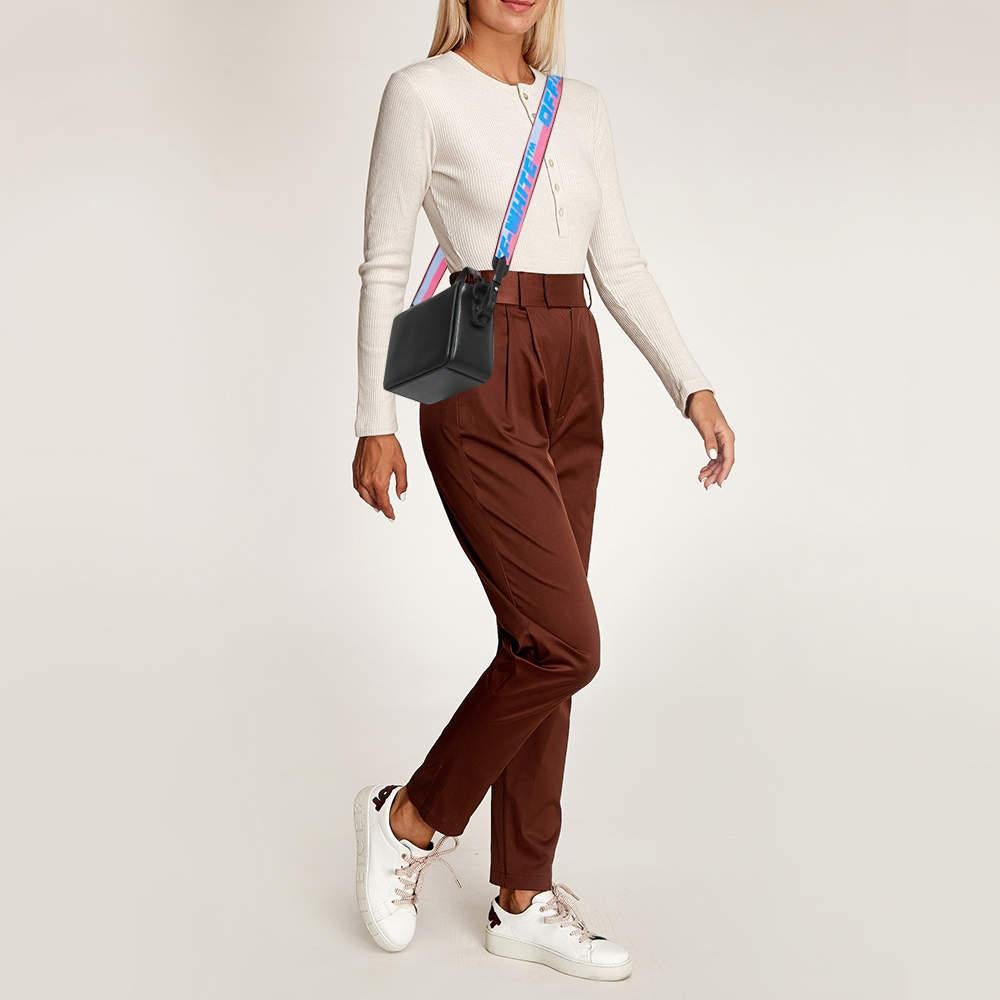 Structured, sophisticated, and stylish are some words that describe this crossbody bag! Crafted from best quality material, the creation is adorned with the label's signature appeal, held by comfortable handles, and equipped with a well-spaced