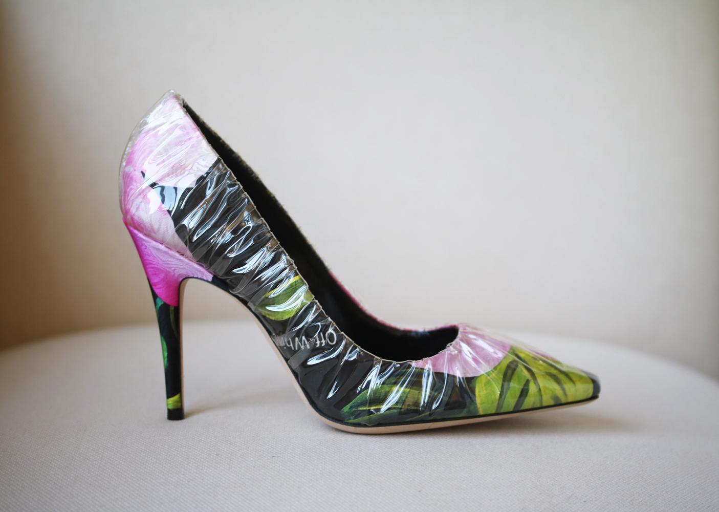 Dedicated to Princess Diana's enduring style and elegance, these 'Anne' pumps have been made in Italy from black satin printed with hothouse florals, then wrapped in clear PVC to resemble glass slippers. Heel measures approximately 100mm/ 4 inches.