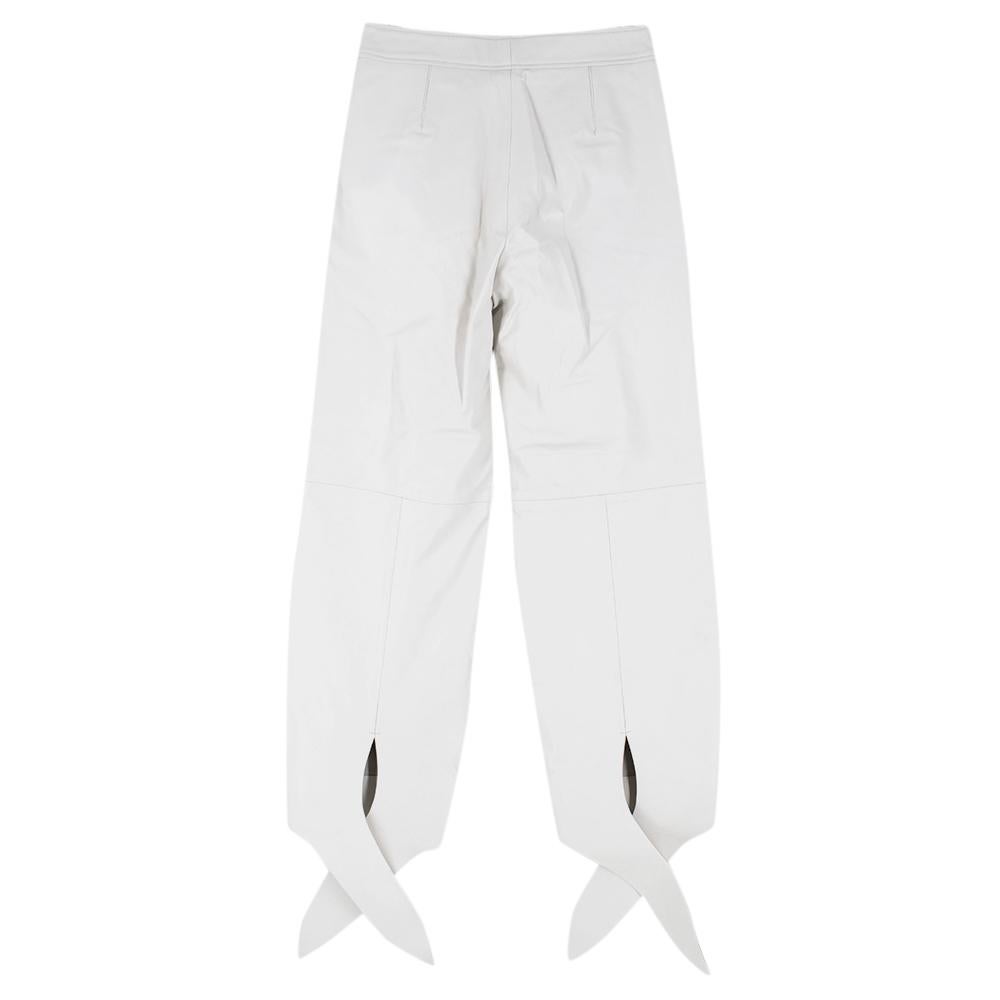 These white leather high-waist balloon-leg trousers from Off-White feature a high waist, a concealed front fastening with a contrast logo detail, side slit pockets, a balloon-style leg and tie details at the ankles. An Off-White 