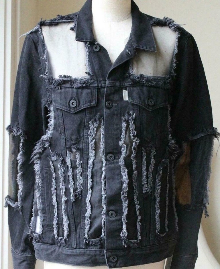 Off-White's denim jacket is slashed and frayed to create the pre-worn look of a thrift store find. It's paneled with sheer organza so it feels lighter than classic styles. Black denim and organza. Button fastenings through front. 100% cotton; trim: