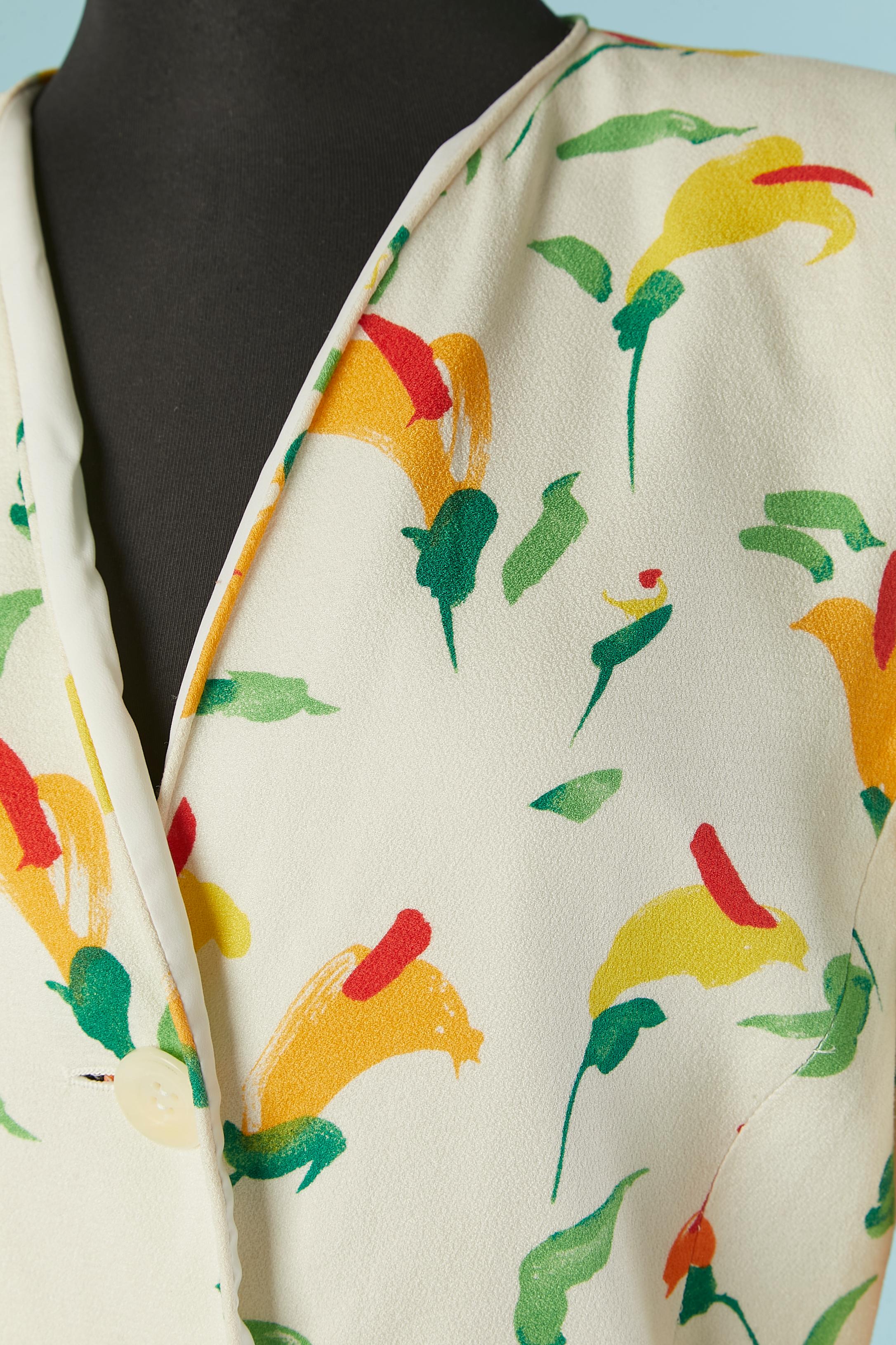 White crêpe single breasted jacket with flowers prints. No fabric composition tag but the lining is probably rayon. 
Button and buttonhole in the middle front and cuffs. Bow on both side on the waist ( which make the waist adjustable)
