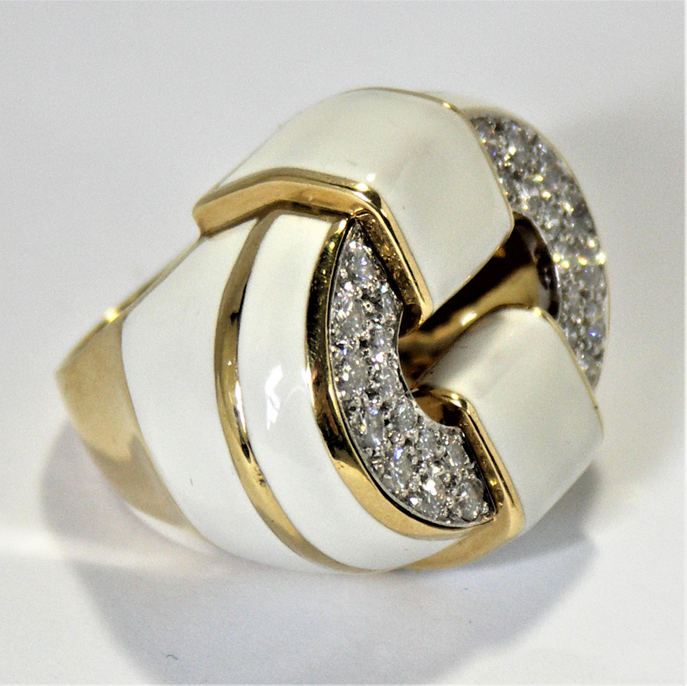 Made of 18K Yellow Gold, this striking off white enamel and diamond ring makes a strong statement. The top oval is pave set with 26 round brilliant cut diamonds weighing an approximate total of 1.00ct of overall G Color VS2 Clarity. Across the top,