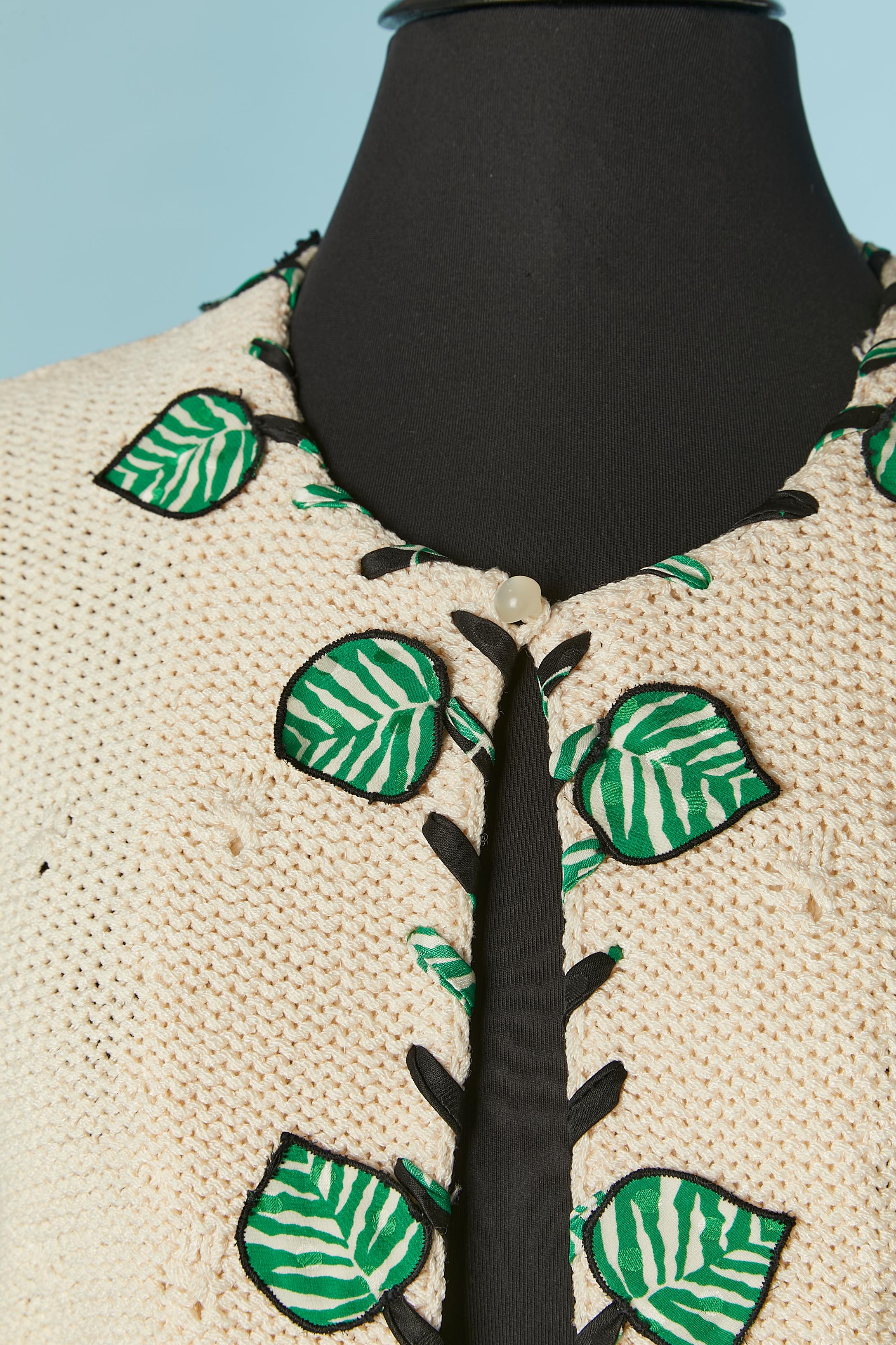 Off-white knit cotton cardigan with fabric leeves appliqué. One button and buttonhole closure on the top middle front. 
SIZE M 
