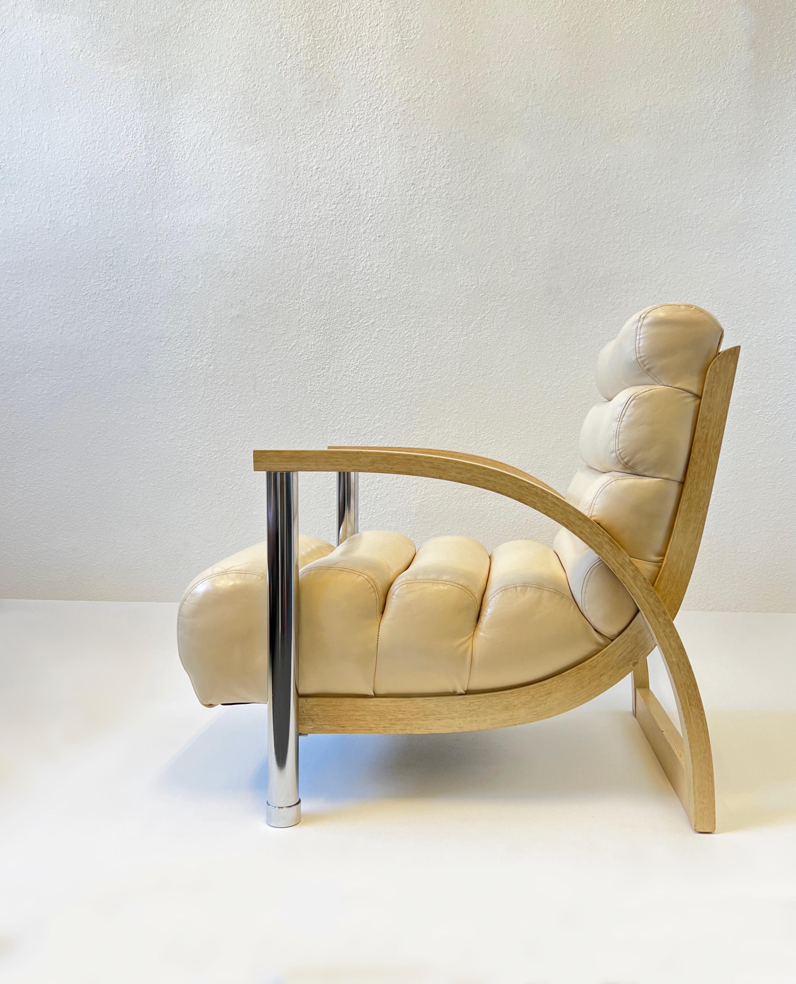 1980’s off white leather, chrome and whitewash oak ‘eclipse’ lounge chair by Jay Spectre. 
In original condition shows minor wear consistent with age. The leather has been professional clean and condition. 

Measurements: 26” wide, 36.5” deep 33”