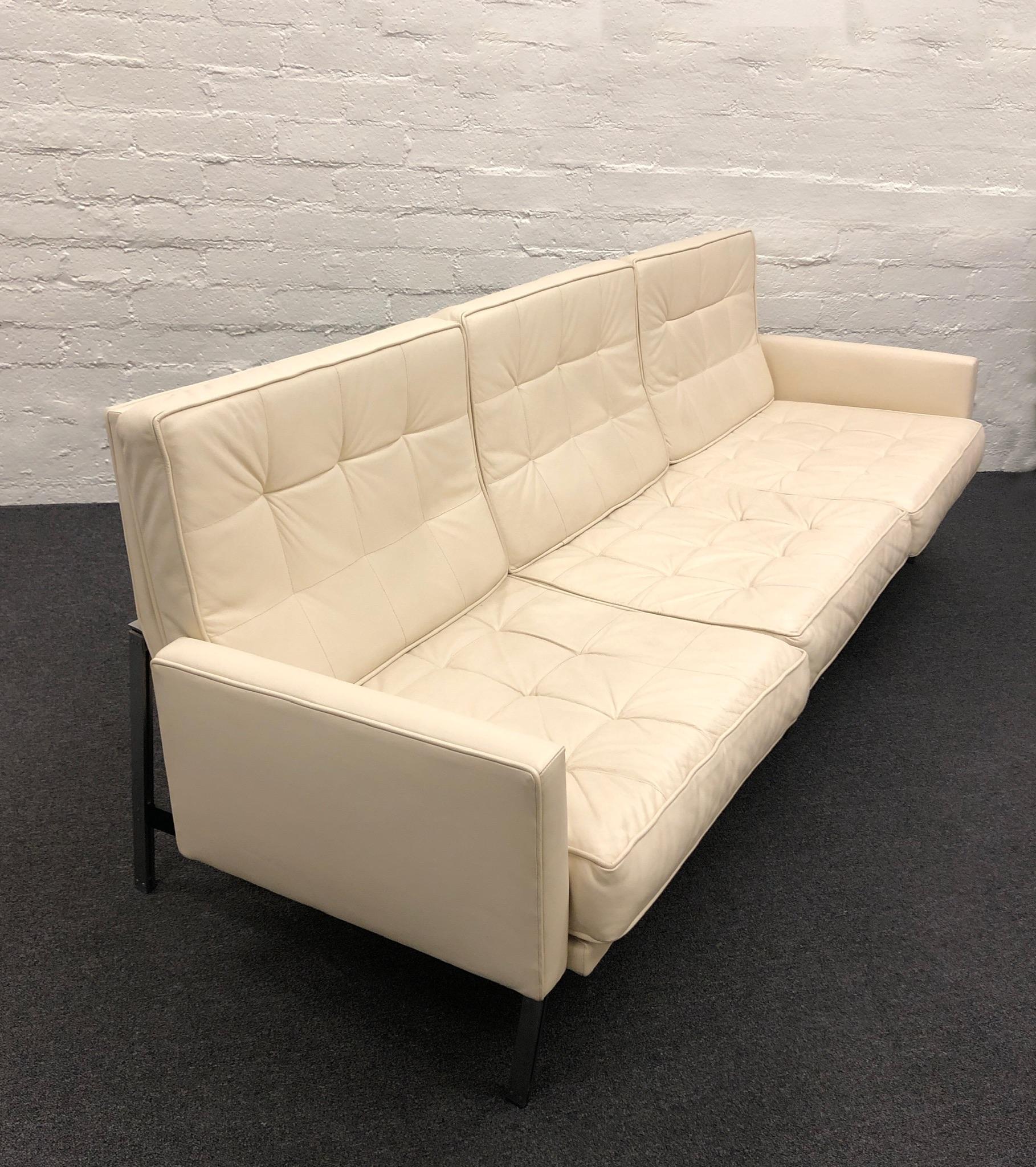 Off white leather and brush stainless steel parallel bar sofa designed by Florence Knoll for Knoll.
This came out of the Australian embassy and retains their label. 
This was  reupholstered about 10 years ago. 
Was used only in winter home. Lounge