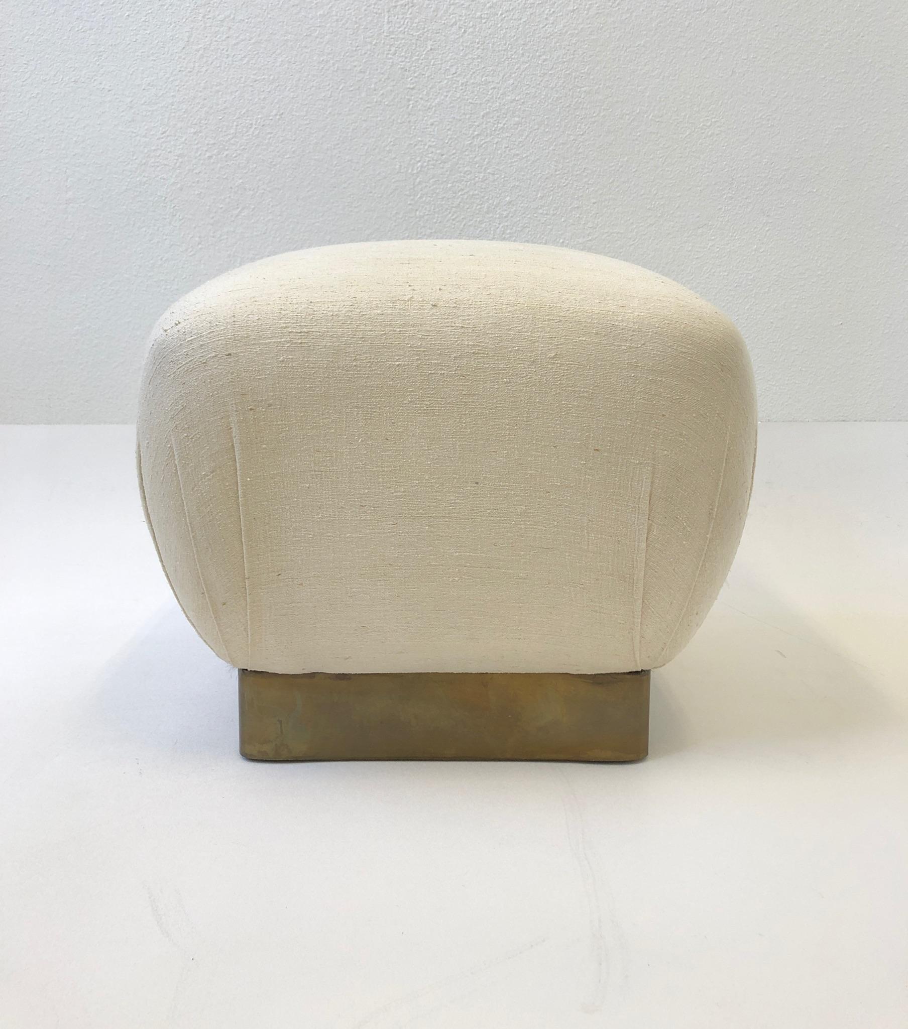 Beautiful 1970’s off white linen and aged brass pouf ottoman by Marge Carson.
Out of a Steve Chase design home, retains original linen fabric.
Measurements: 19” wide, 19” deep and 17” high.
 