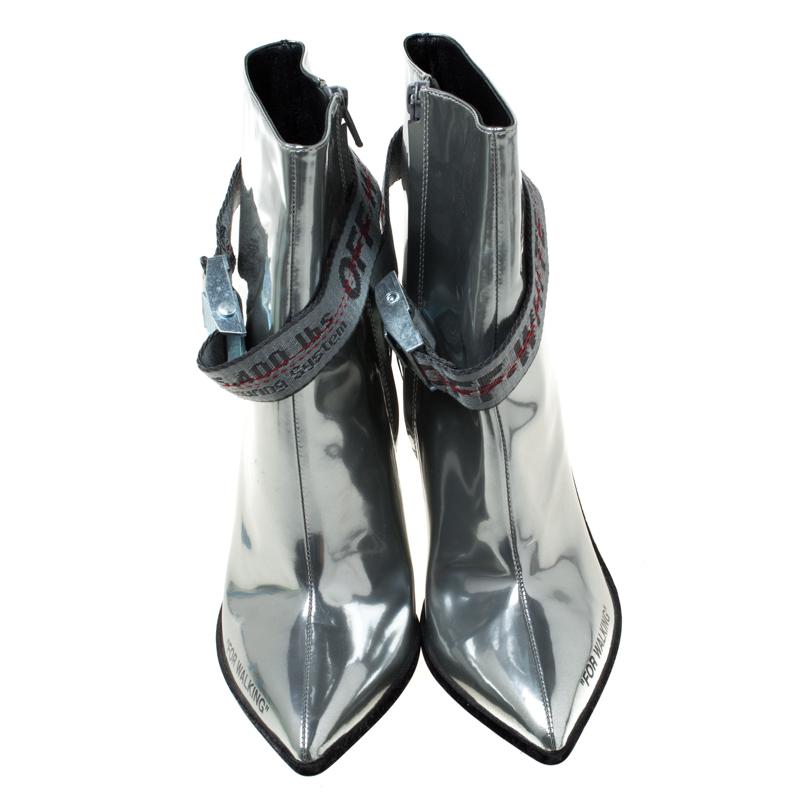 A pair of finely crafted leather boots to complement the chic, style-conscious person in you. Carry a smart look every time you head out wearing these trendy metallic silver boots which come equipped with fun details like the 'For Walking' slogan on