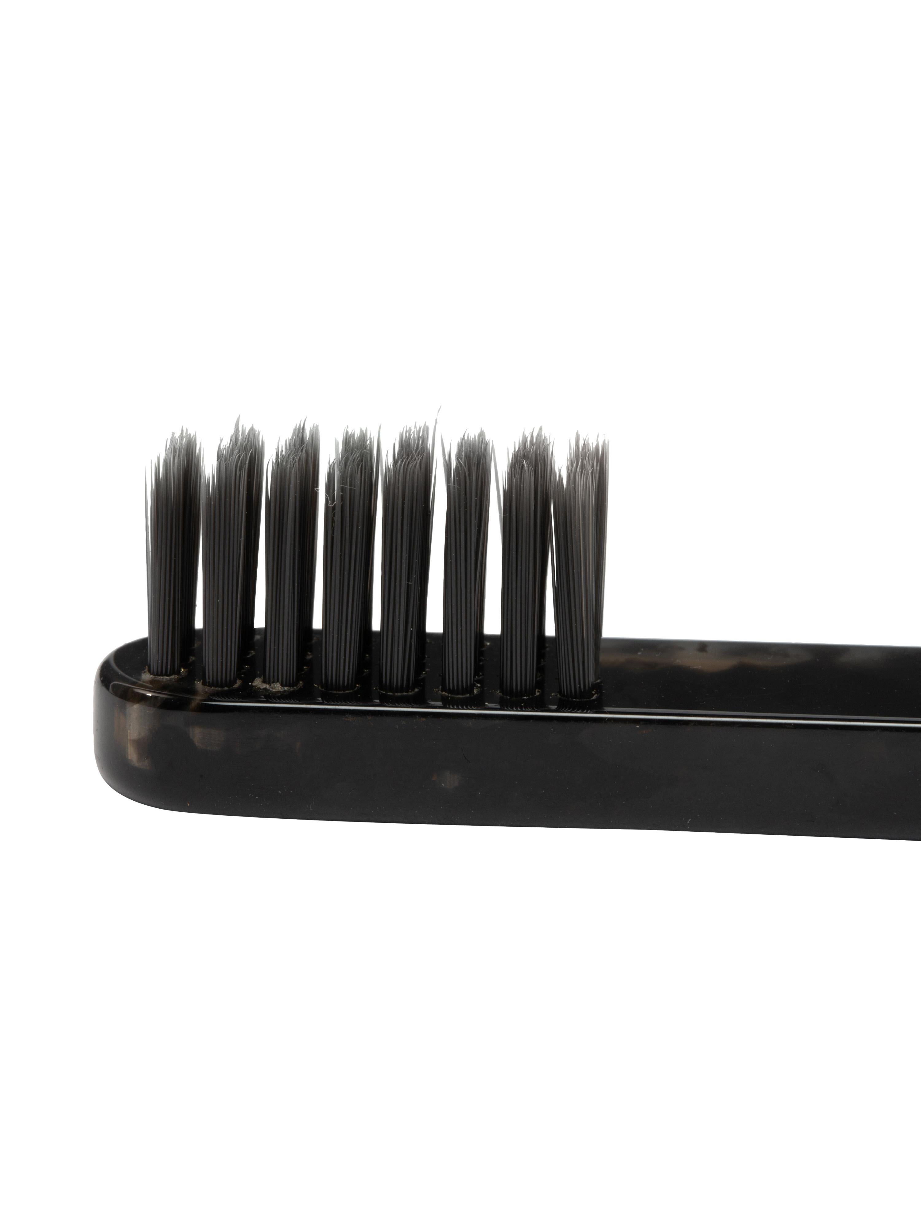 Tooth brush made of synthetic carbon soft black bristles. Handle is holed with man swimming logo gold impressed
By Virgil Abloh
Dimensions: 1.3 W x 17 H
This item is only available to be purchased and shipped to the United States.