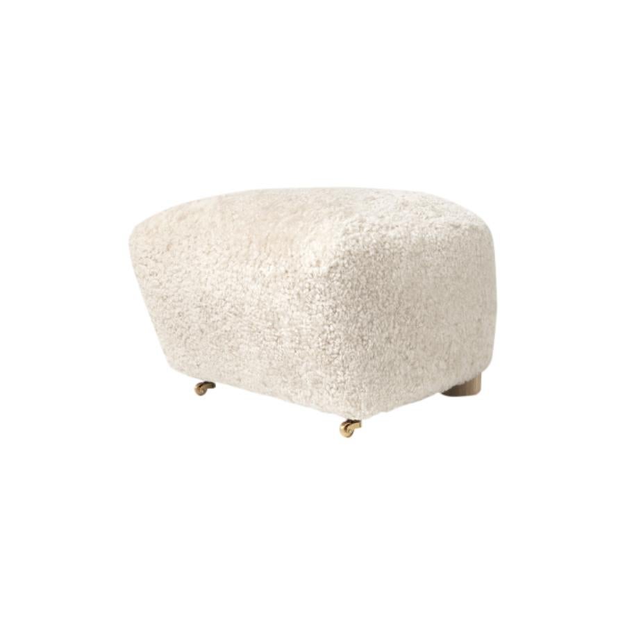 Off white natural oak sheepskin the tired man footstool by Lassen
Dimensions: W 55 x D 53 x H 36 cm 
Materials: Sheepskin

Flemming Lassen designed the overstuffed easy chair, The Tired Man, for The Copenhagen Cabinetmakers’ Guild Competition in