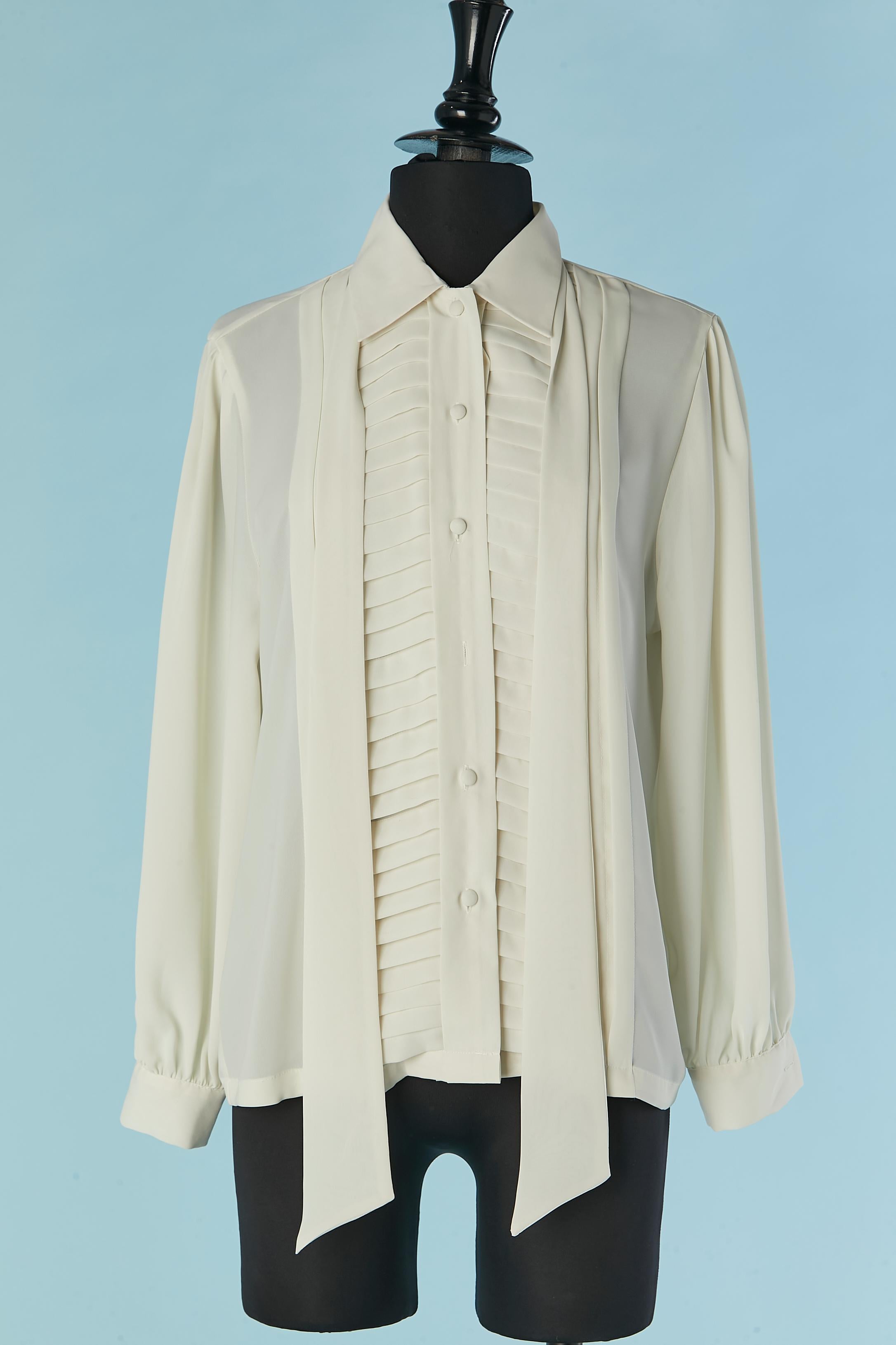 Off-white  pleated shirt with bow tie. Fabric composition: 100% polyester. 
Button and buttonhole closure on the middle front. Small thread loop behind the neck to hold the scarf. 
SIZE 6 (Us) M 