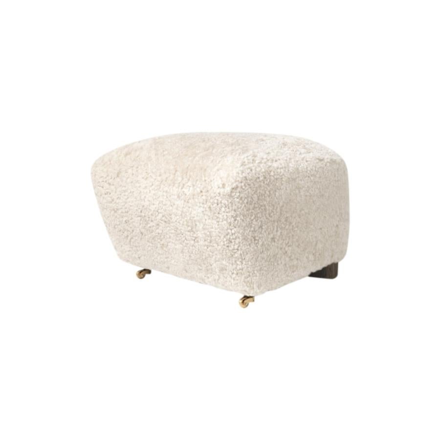 Off white smoked Oak Sheepskin the Tired Man footstool by Lassen
Dimensions: W 55 x D 53 x H 36 cm 
Materials: Sheepskin

Flemming Lassen designed the overstuffed easy chair, The Tired Man, for The Copenhagen Cabinetmakers’ Guild Competition in