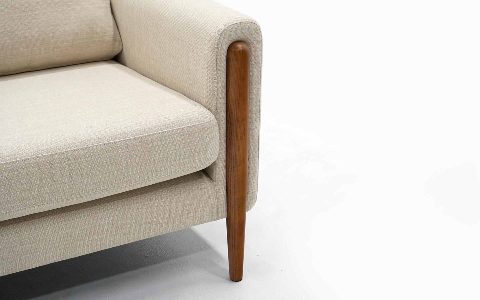 white sofa with wood legs