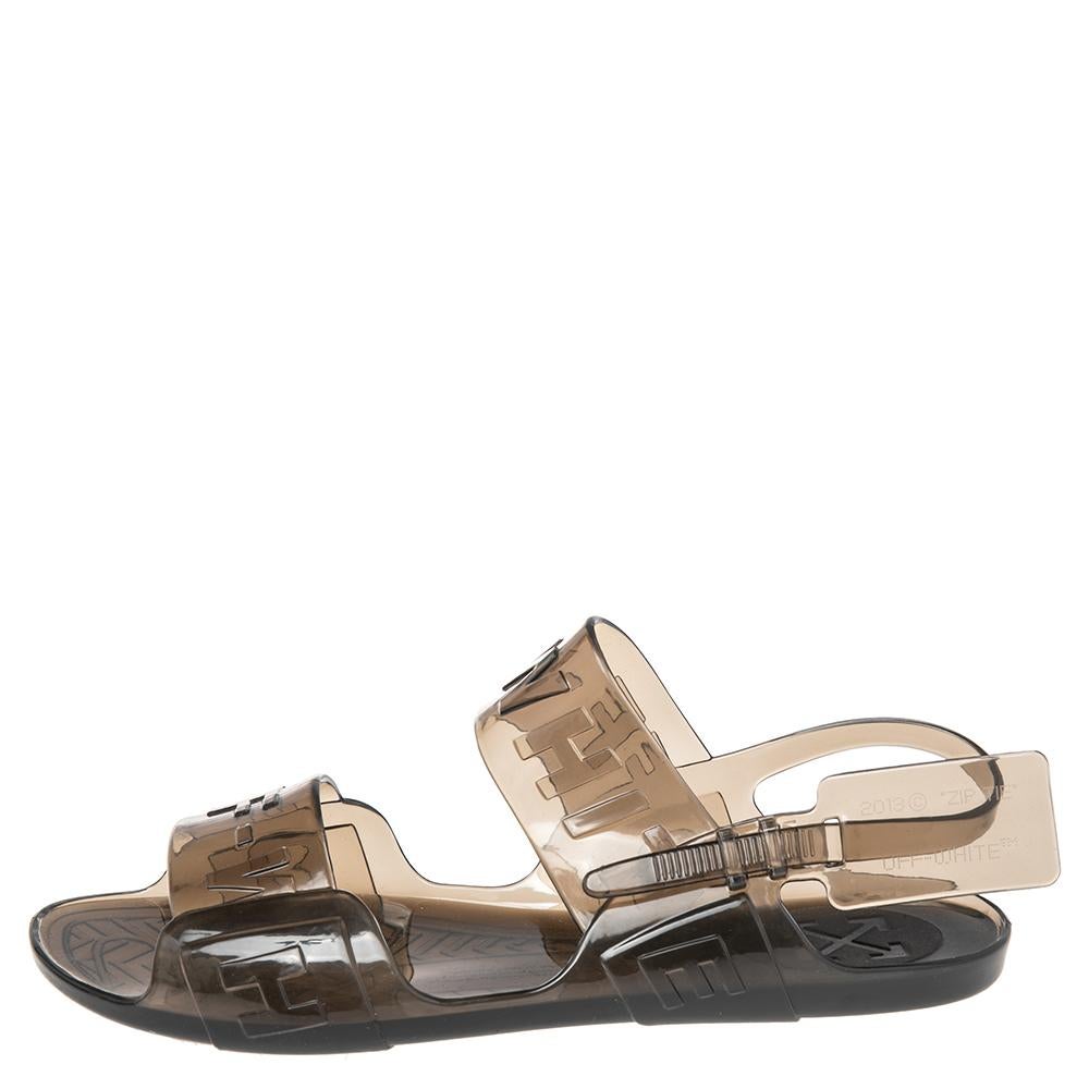 You're all set to shine in these lovely sandals from Off-White. The transparent black flats are crafted from jelly and feature an elegant silhouette. They flaunt brand label-detailed straps and slingbacks. Pair them with dresses or pleated skirts