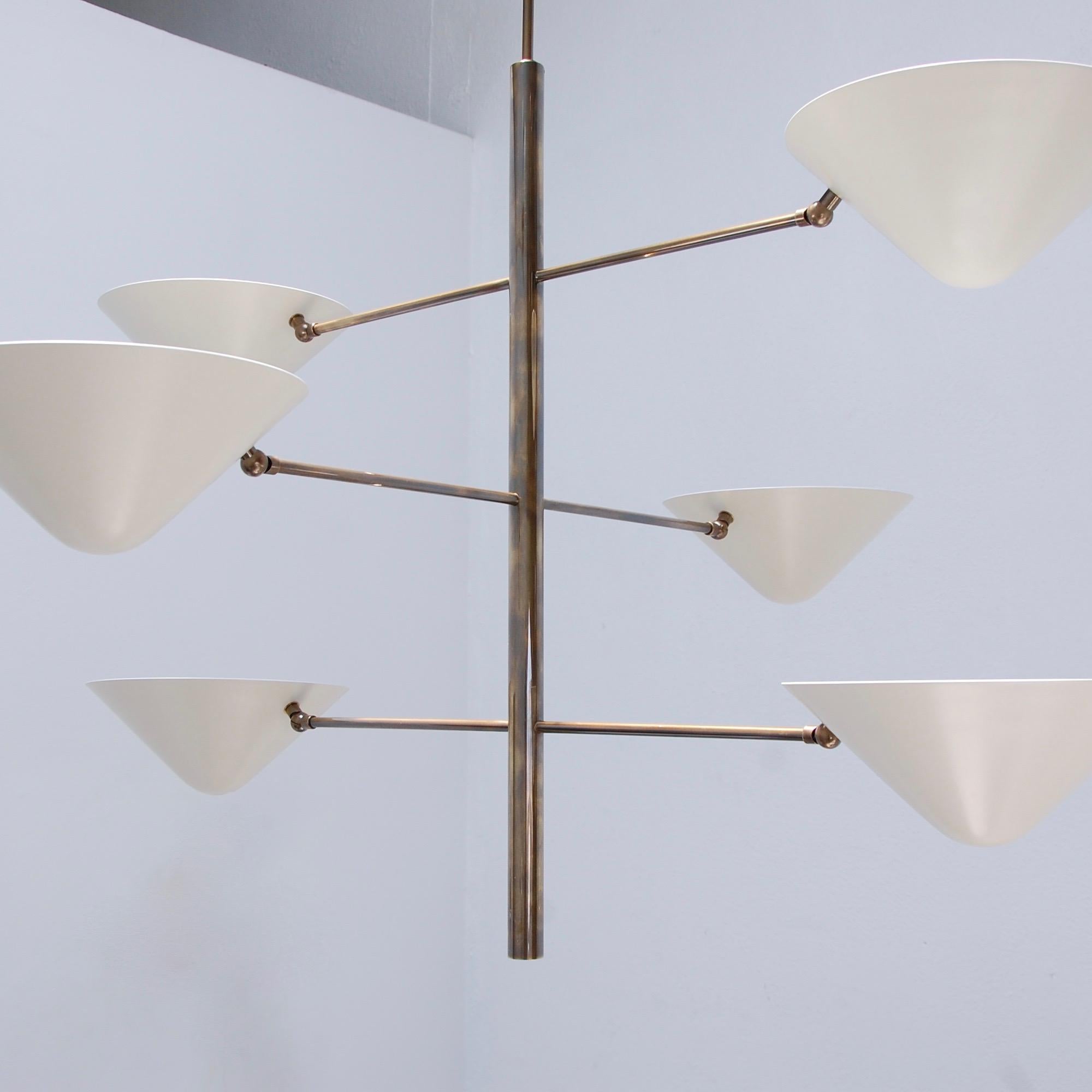 Organic inspired chandelier that combines geometry with botanical aspects. Having six top open shades for indirect lighting. A single medium based E26 socket per shade. Made in custom sizes, but standards are listed.
Brass and painted aluminum.