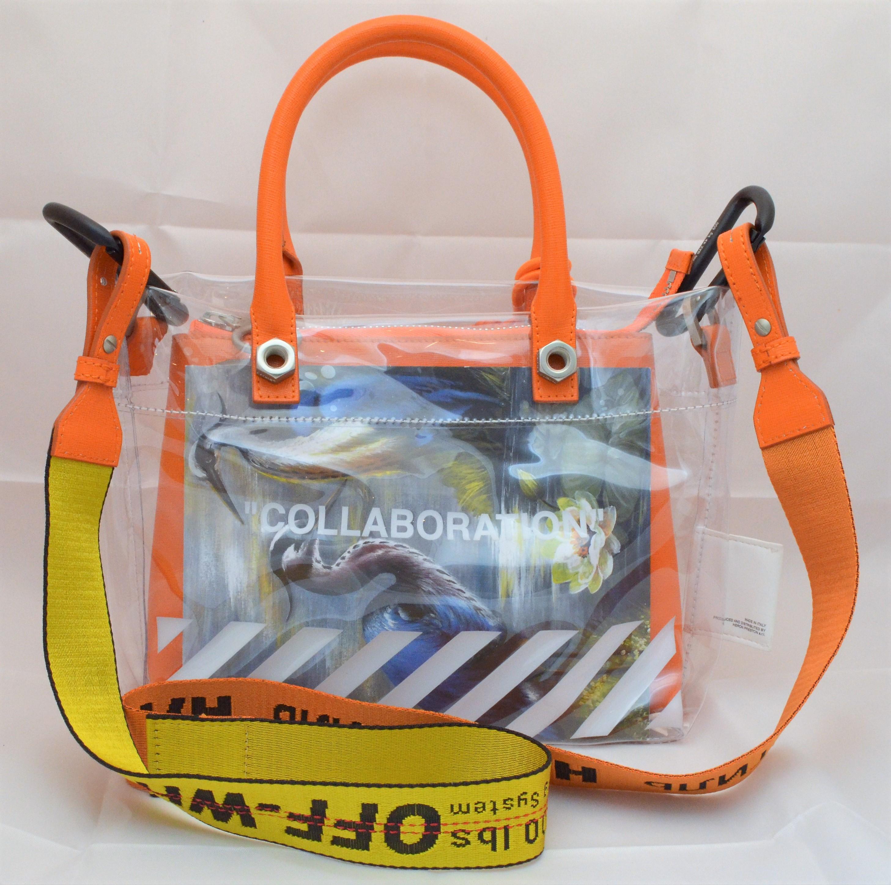 Off White x Heron Preston Collaboration Tote Bag with Industrial Shoulder Strap -- PVC tote with orange leather trimmings and dual rolled handles, removable industrial shoulder strap, orange and white leather zip pouch that is also removable, front