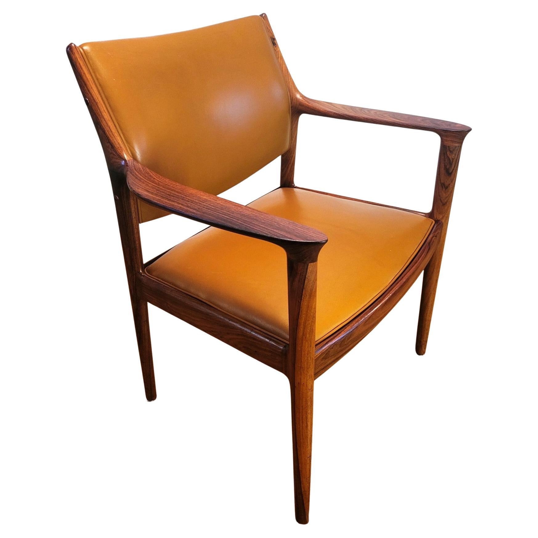 Beautiful and rare Elton model armchair designed by Torbjorn Afdal and manufactured by Bruksbo-Nesjestranda, Norway in the 1960's. The structure is made of solid palissander, in a deep color and has an impressive wood grain that combines elegantly