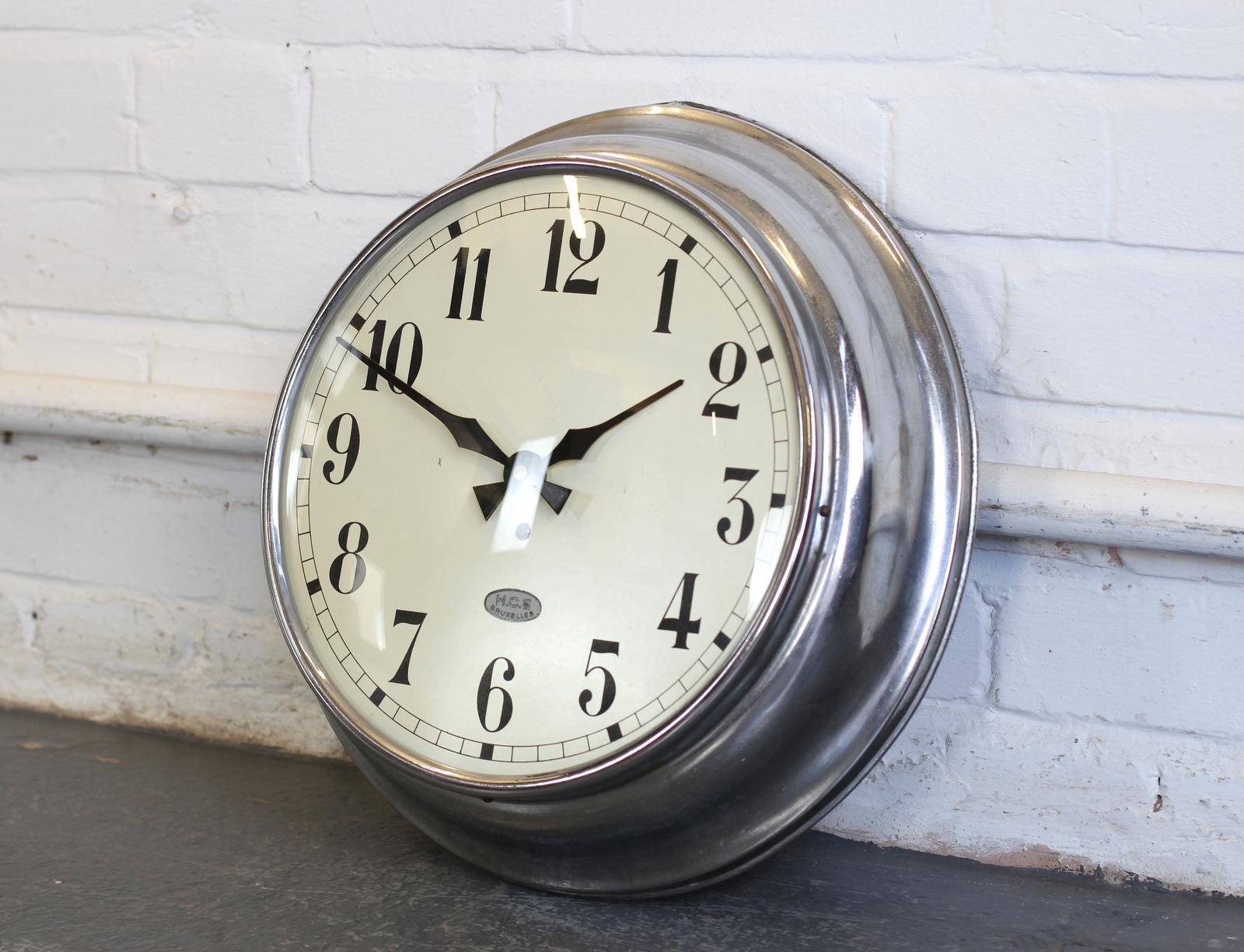 Office clock by HCE, Brussels, circa 1930s.

- Domed glass face
- Tin dial with makers badge
- Chrome casing
- New AA battery powered motor
- Belgian, circa 1930s
- Measures: 39cm wide x 39cm tall x 9cm deep.

Condition report:

Fully