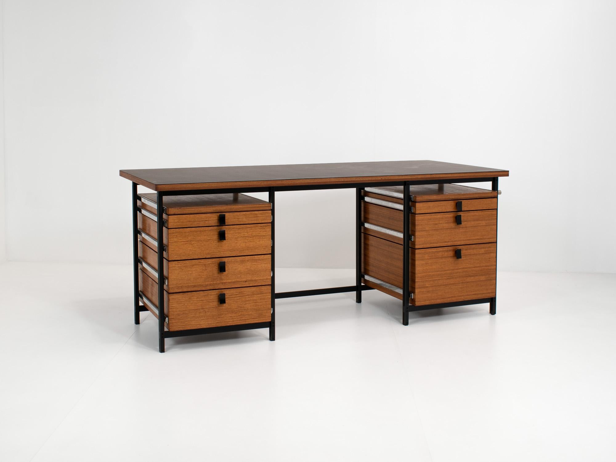 Writing desk or office desk designed by Belgian designer Jules Wabbes for Mobilier Universel in the 1960s . 
Desk consists out of one table, a black metal frame, two chests of drawers in teak and runners in chrome. The handles are engraved with