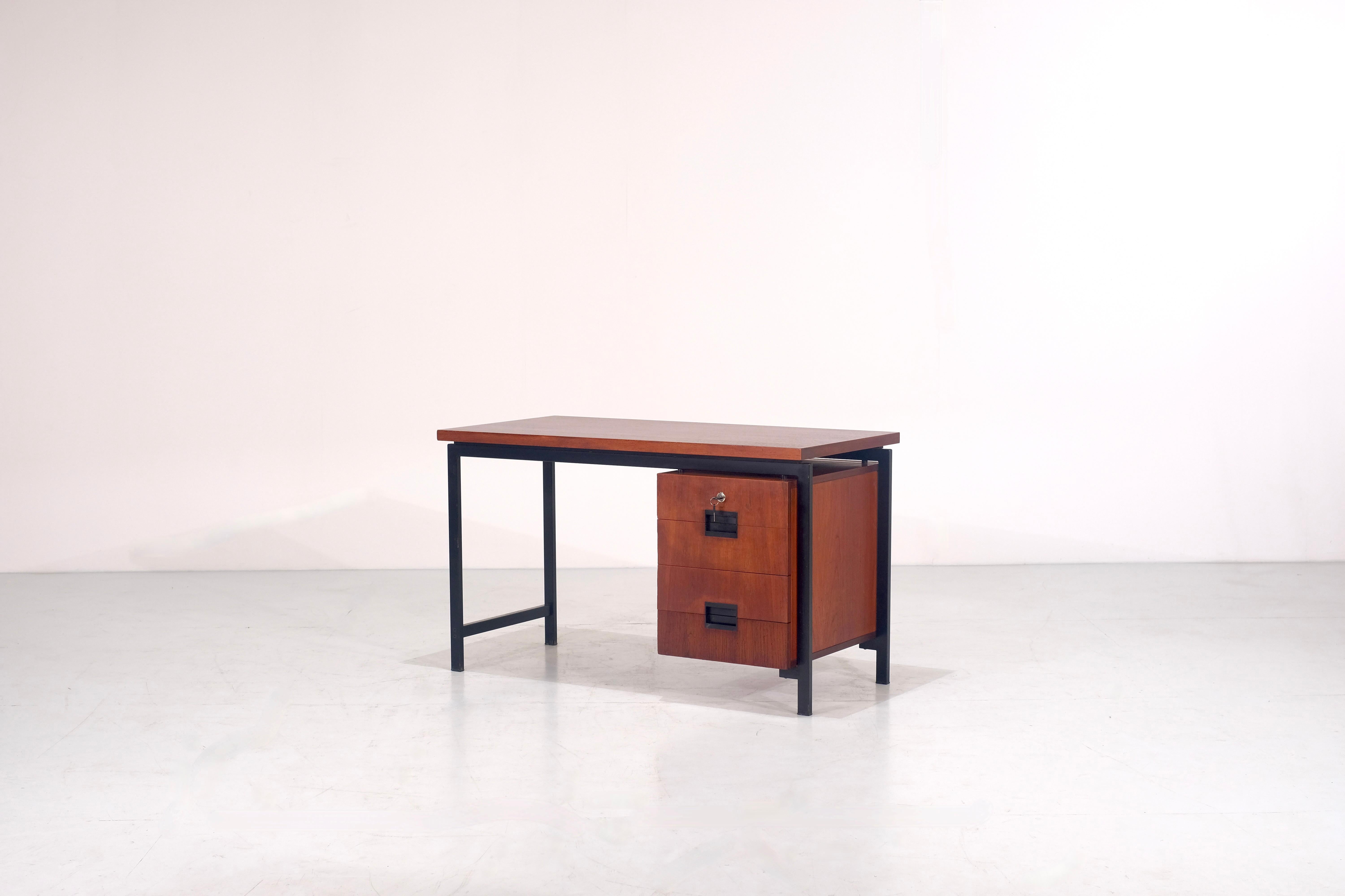 Nice office Desk model EU01 of the Japanese Series by Cees Braakman for Pastoe created between 1950 and 1960.
This desk is made of teak wood and has a black lacquered metal frame. The handles are made of black moulded plastic and It has four drawers
