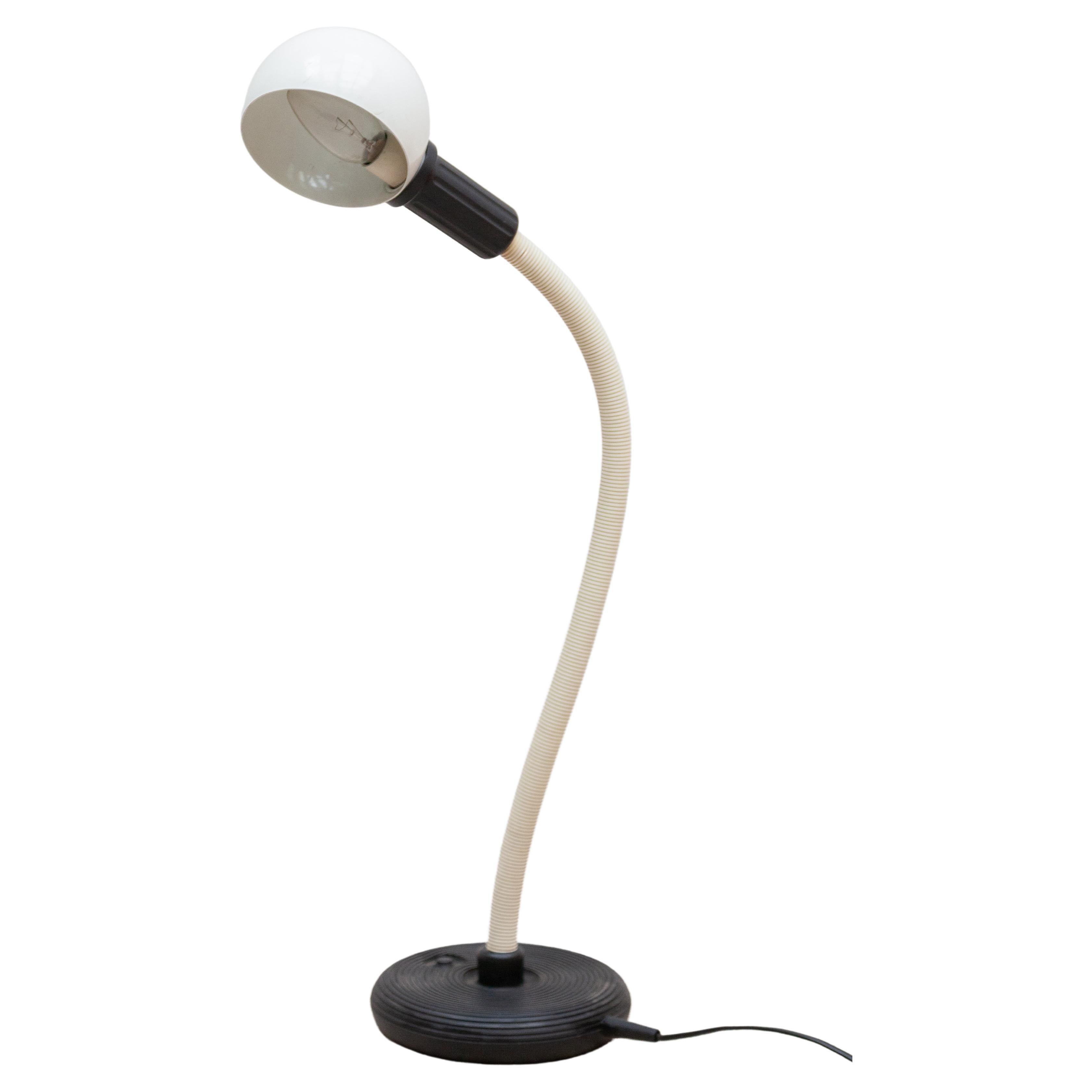 Adjustable 'Hebi' desk lamp by Isao Hosoe for Valenti in Milano, Italy 1970s. In good original condition. Black ribbed rubber base with a metal counterweight inside. Black ribbed flexible tube with a metal gooseneck inside. White painted aluminium