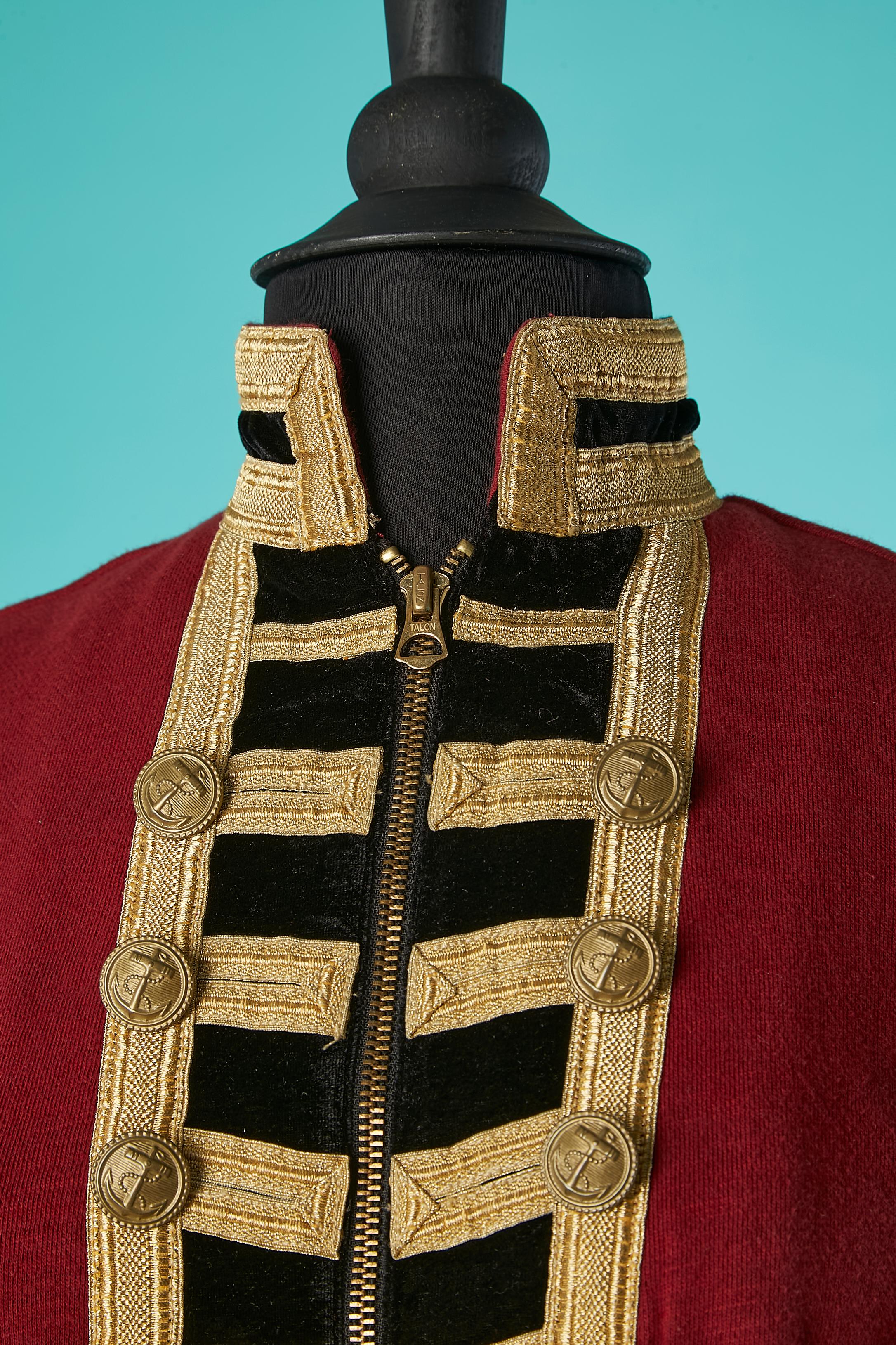 Officer jacket in red cotton sweat-shirt and gold trims ( fabric composition: 95% polyester, 5% elastane) 
Zip in the middle front. Decoratives buttons. middle front and cuffs. Pockets on both side.
SIZE S 