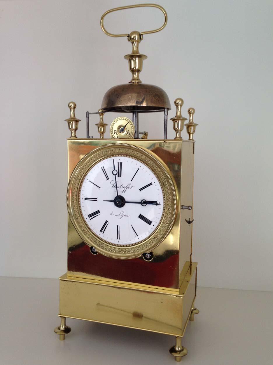 A fine French brass Capucine Officers clock, circa 1820, by well regarded maker Hastroffer a Lyon who specialised in this type of clock.

The clock is of typical form with doors to the sides and rear for access to the movement and pendulum, urn