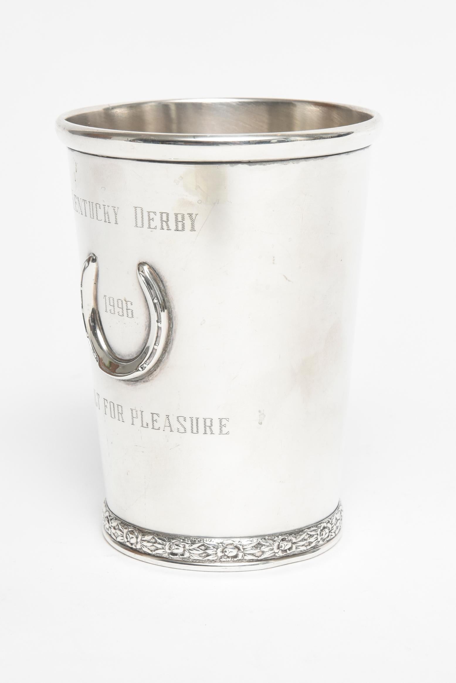 Classic sterling silver Kentucky Derby mint julep cup commemorating the 1996 race. Engraved Kentucky Derby 1996 Built For Pleasure. The cup has a raised horseshoe, molded rim, tapering sides and a chased floral design on the bottom rim. On the