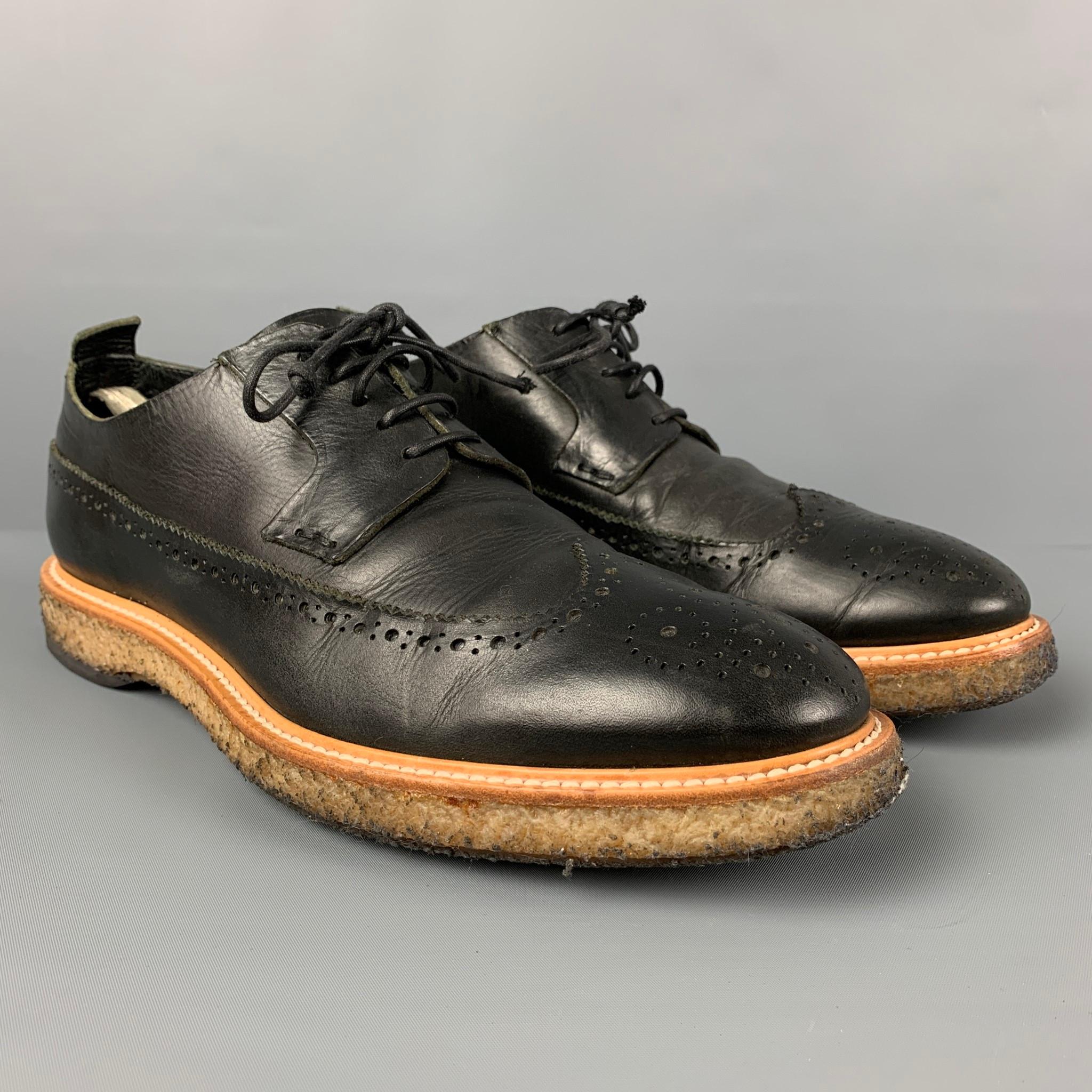 OFFICINE CREATIVE shoes comes in a black perforated leather featuring a wingtip style, crepe sole, and a lace up closure. Made in Italy. 

Very Good Pre-Owned Condition.
Marked: 44

Outsole: 13 in. x 4.5 in. 