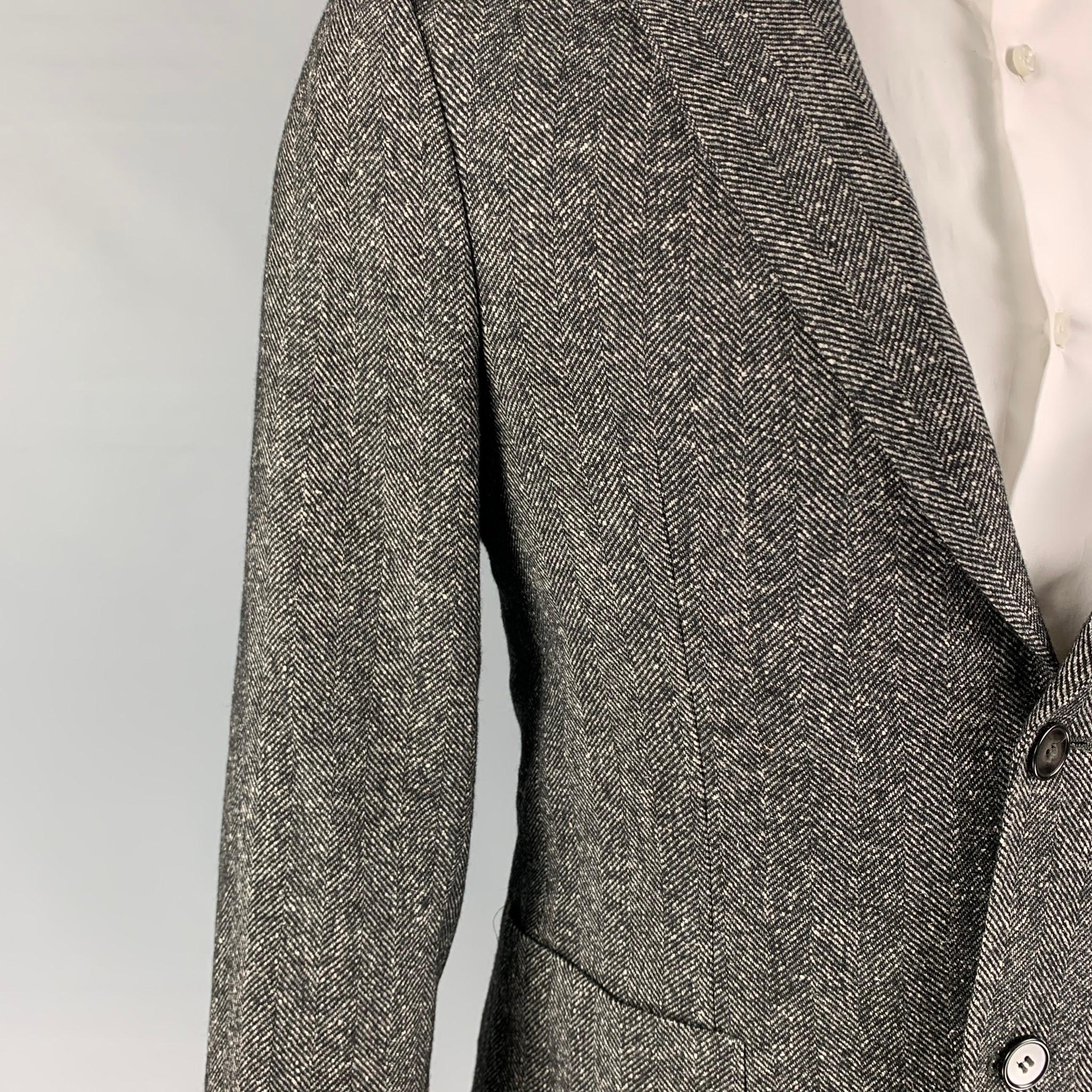 OFFICINE GENERALE sport coat comes in a black & white herringbone wool / silk with a full liner featuring a notch lapel, patch pockets, double back vent, and a double button closure. 

Excellent Pre-Owned Condition.
Marked: