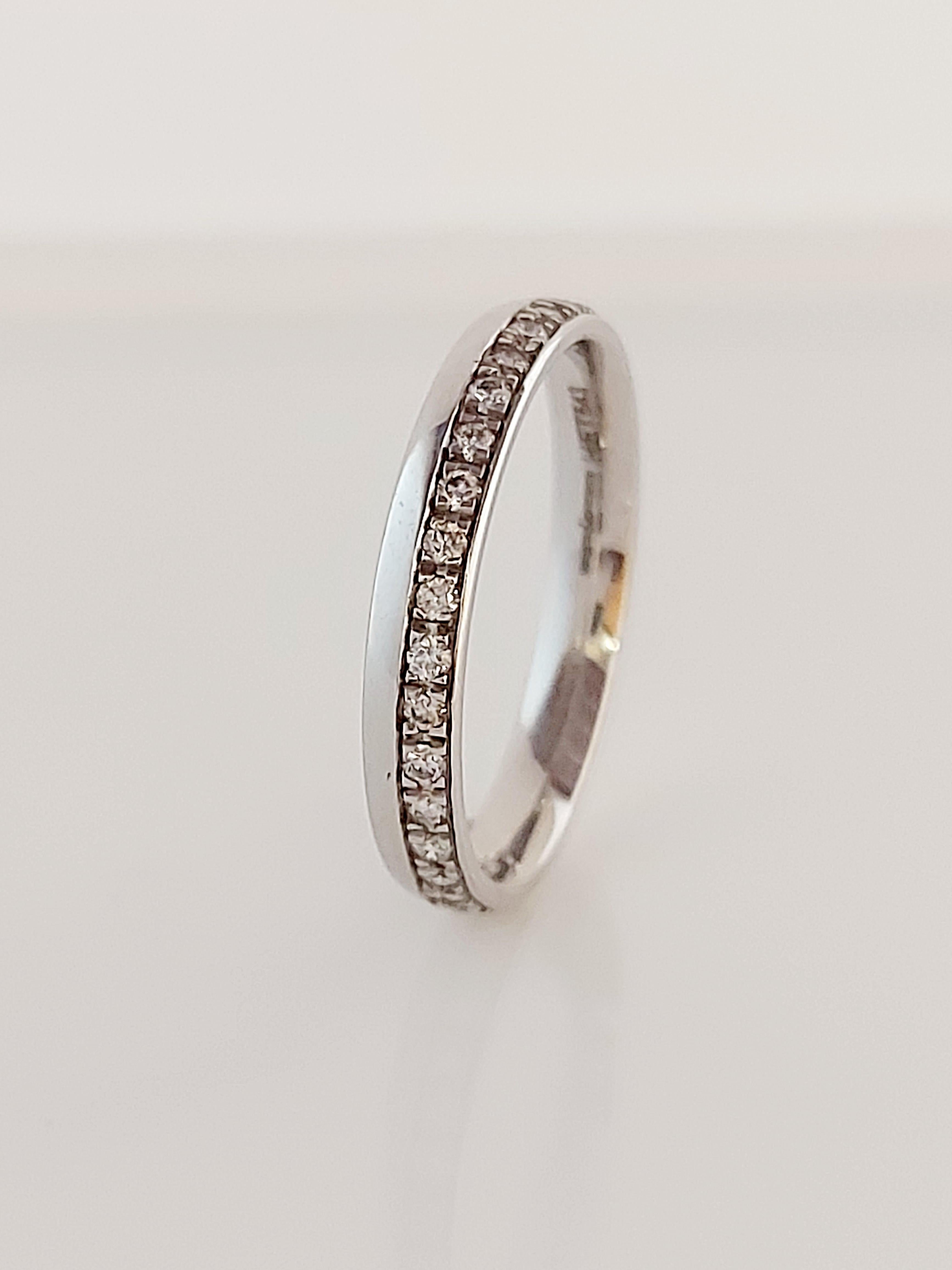 Offset diamond band ring brilliant cut diamonds grain set along edge, total diamond weight.22ct, hallmarked 18ct white gold. Handcrafted by Brown & Newirth model no HET543.