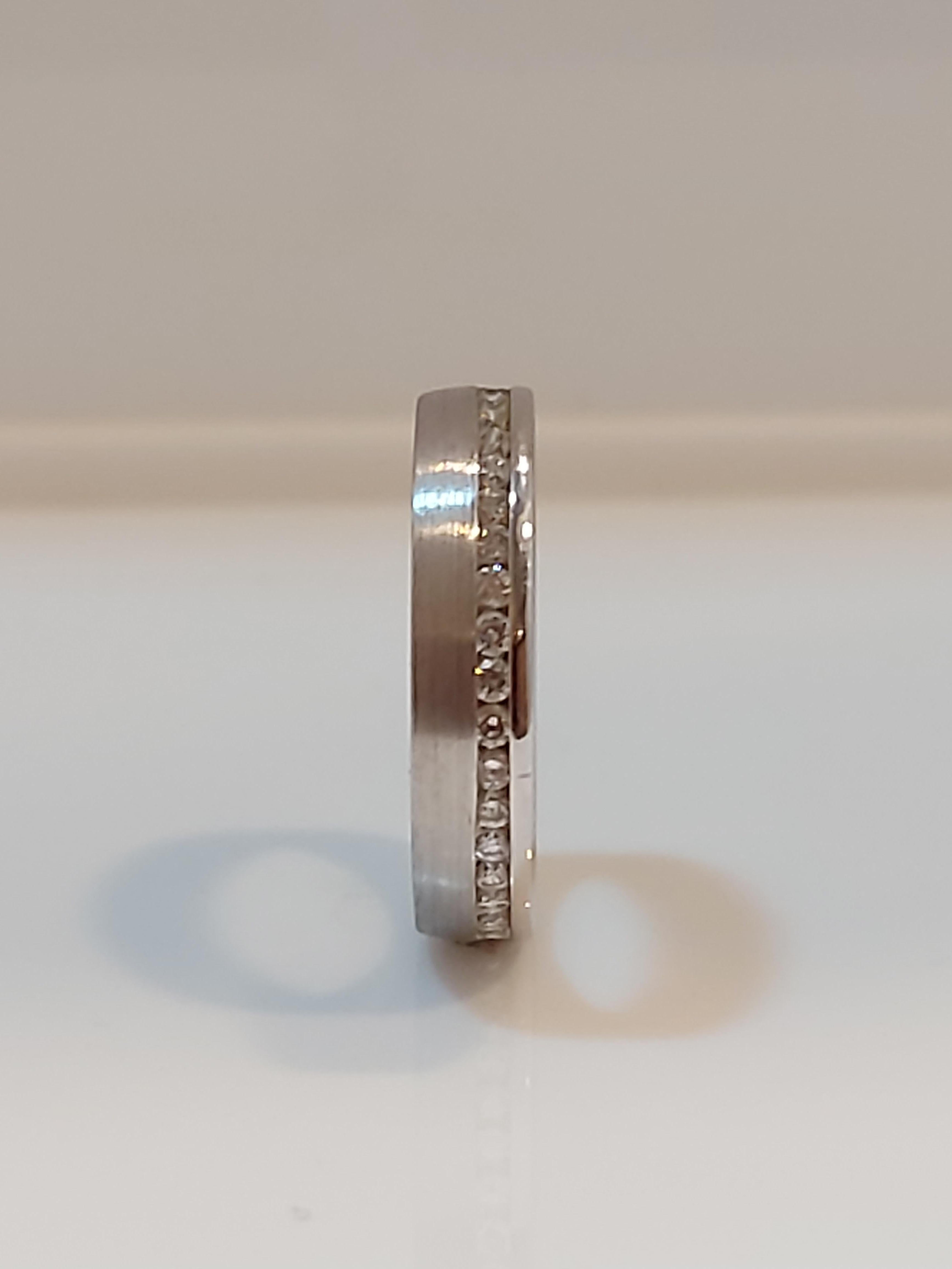 Offset diamond band ring, brilliant cut diamonds total weight .50ct colour G, clarity SI1, set along one edge of band. Matt finish with fine polished edge and classic court detail, made by Brown and Newirth model no ET109,