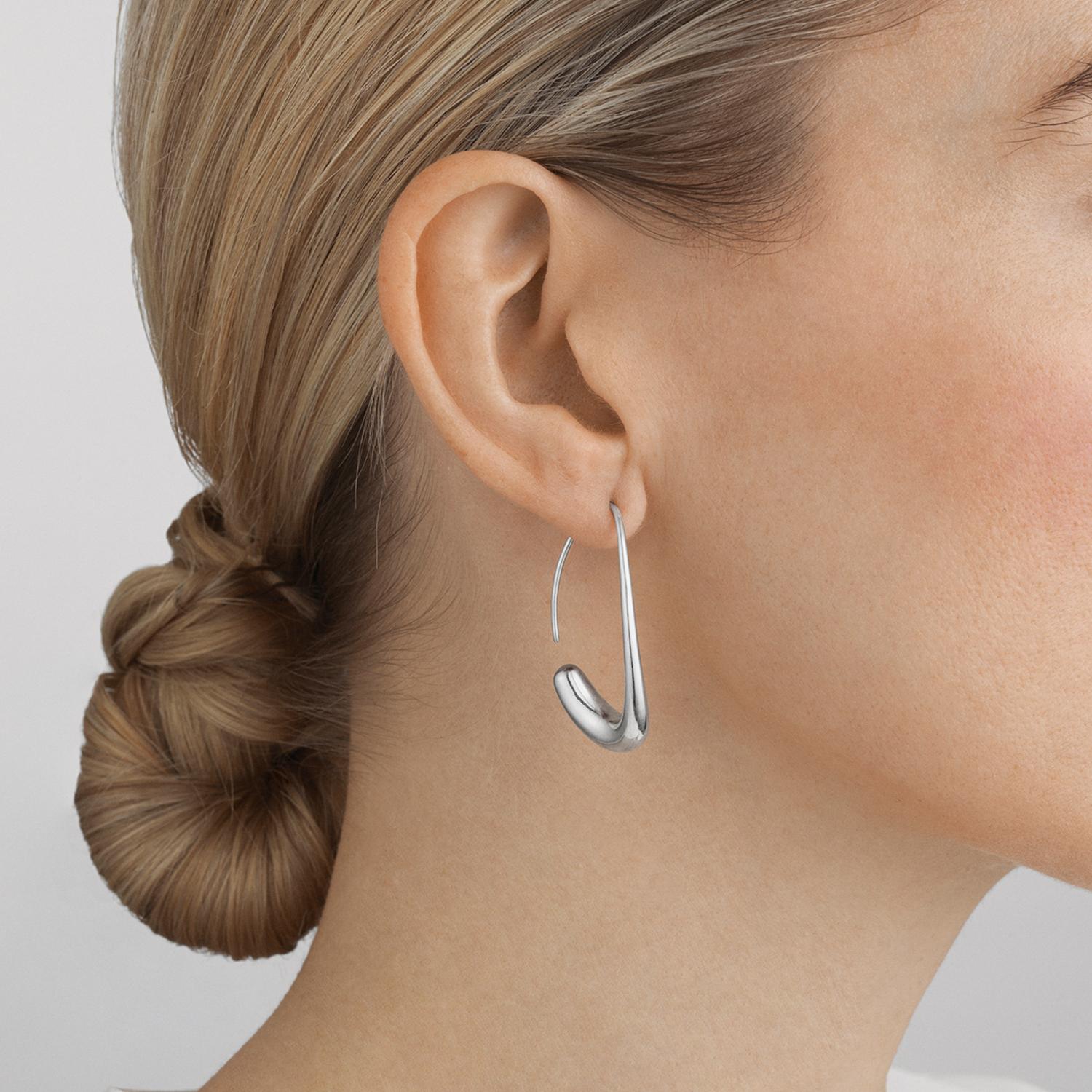 Combining expert craftsmanship with striking design, these sterling silver hoop earrings capture the essence of Scandinavian style. The minimal organic shapes are understated and elegant and reflect the individuality of the wearer in a sophisticated