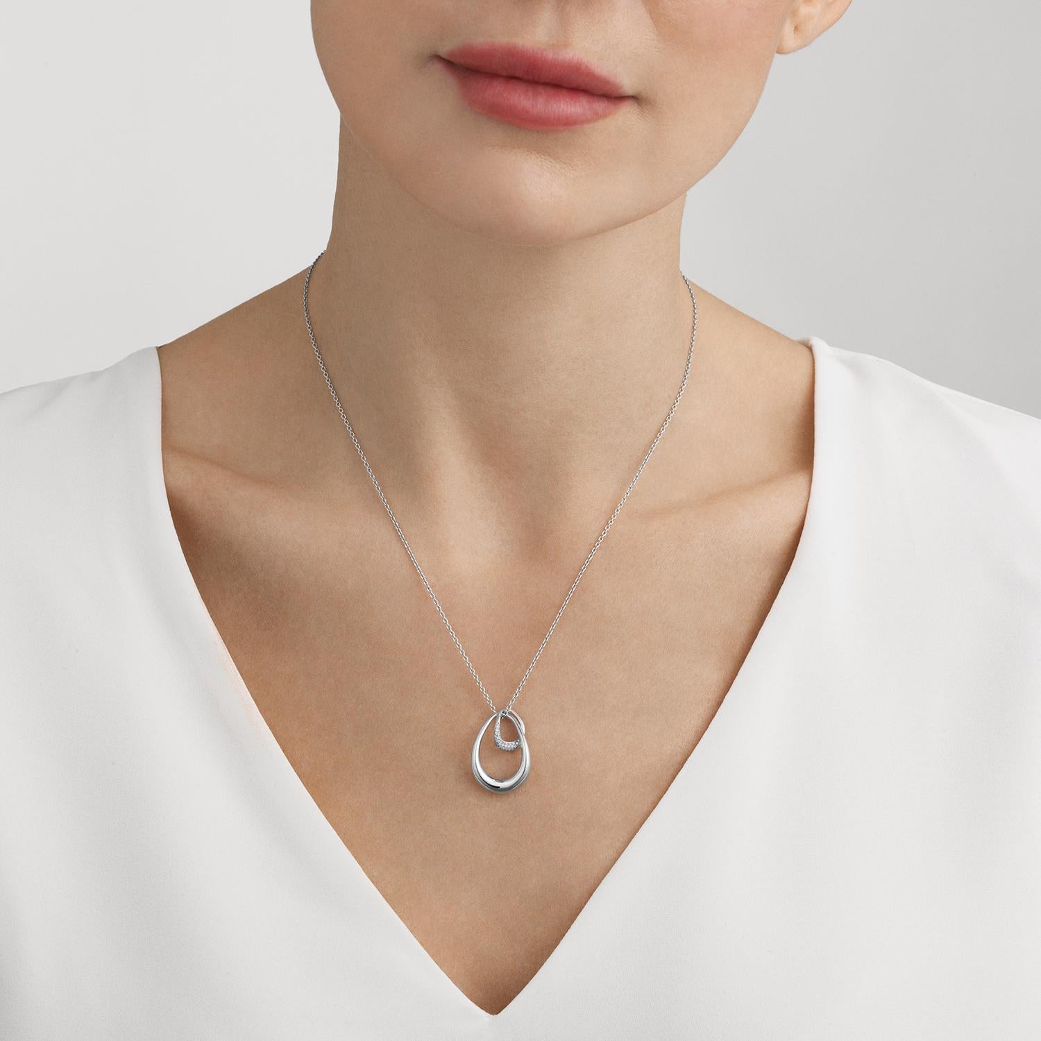 Two sterling silver organic forms - one pavé set with diamonds - are linked together forever, symbolising perhaps the bond between mother and child, two lovers or even close friends. This beautifully designed pendant has an emotional impact that