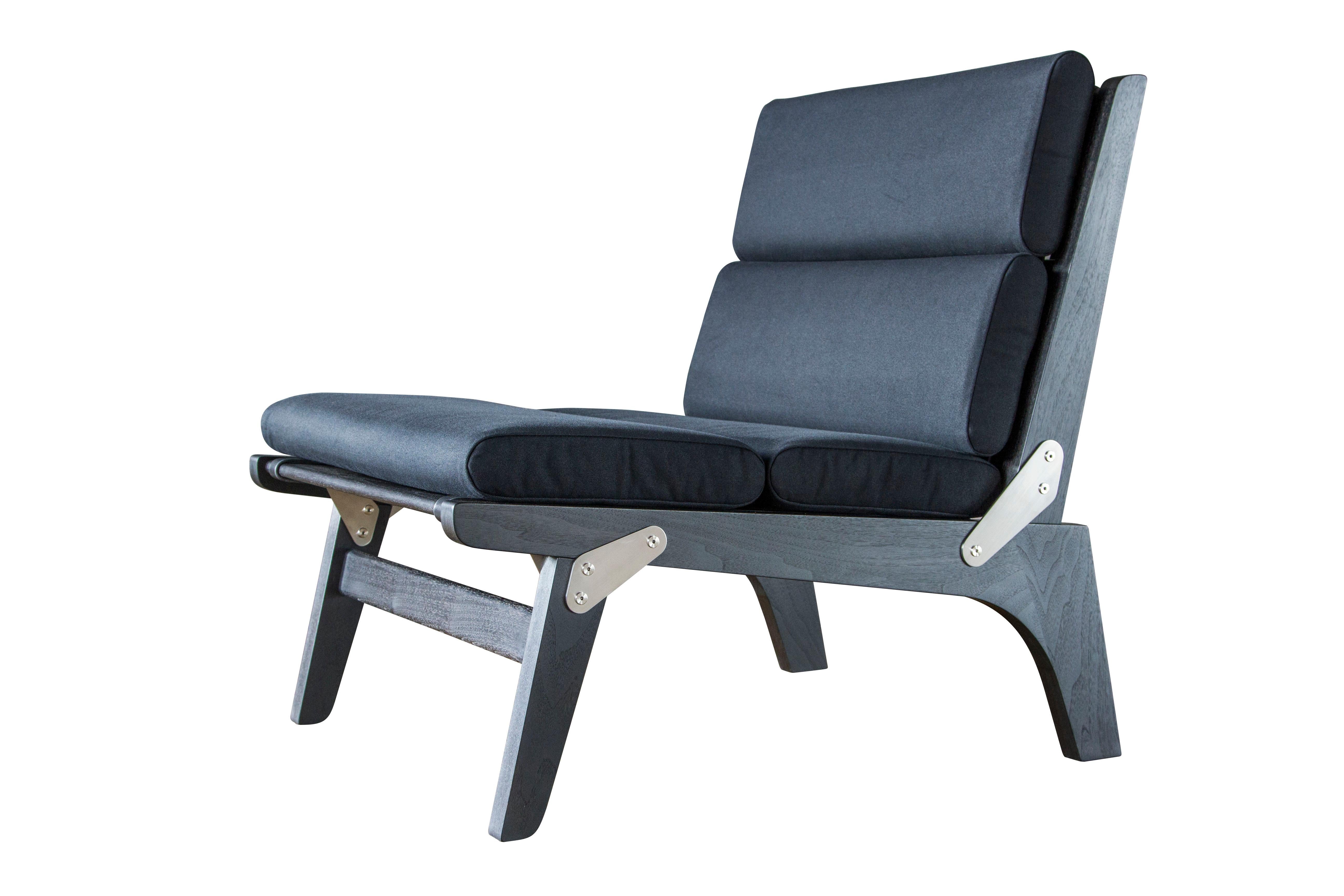 The Officer's Field Set lounge chair shown here as the non-folding version in ebonized walnut, black canvas, English bridle leather strapping and brushed stainless steel hardware. 

The modern campaign collection by Richard Wrightman combines the