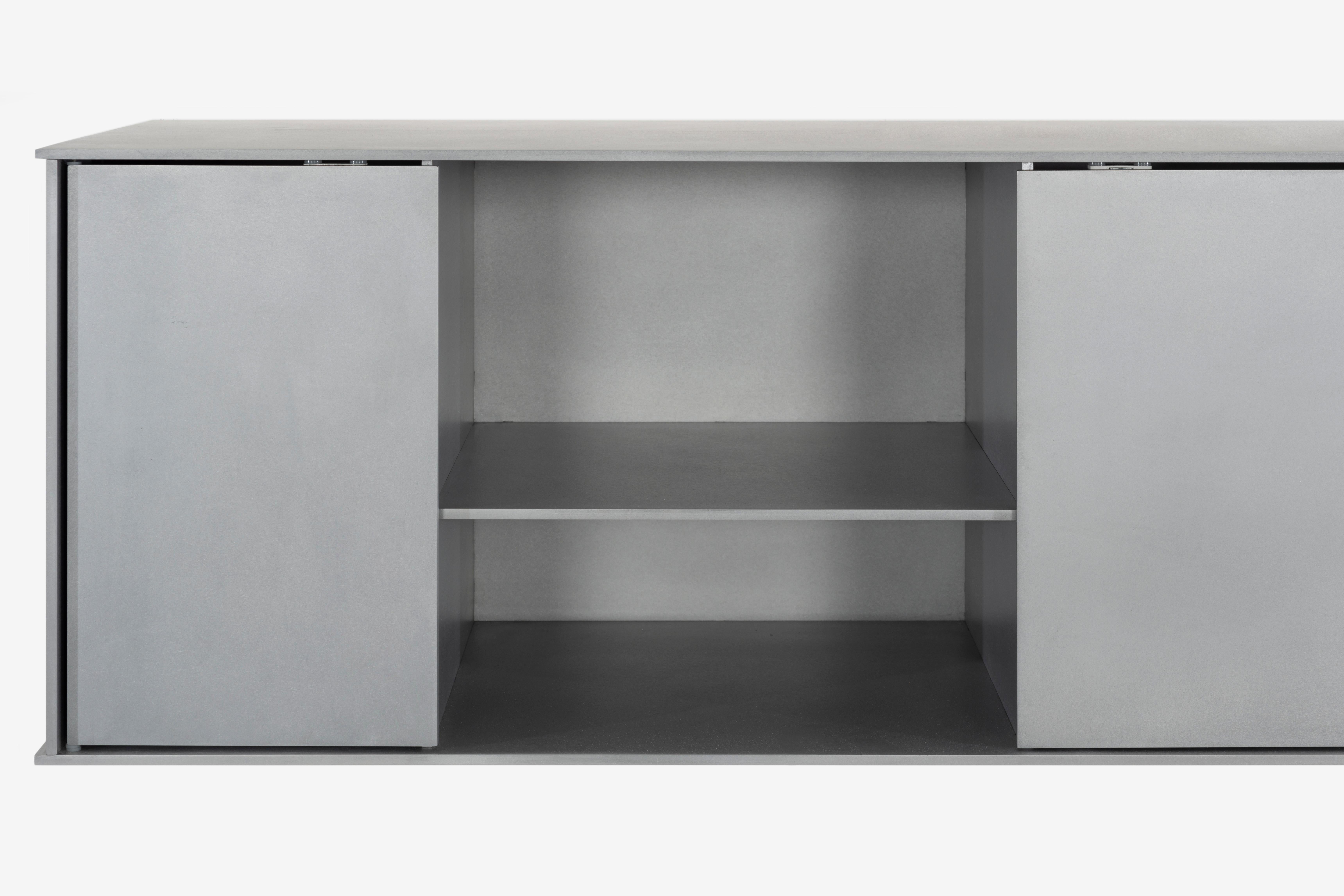 The Minimalist wall-mounted G shelf is sculpted out of 1/4 inch thick, wax-polished aluminum with two Minimalist pin-hinged doors. Each shelf has an inset welded U-channel that spans the length of the shelf and easily mounts on included custom-bent
