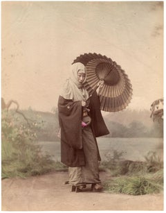 Antique Japan – Woman in winter outfit with umbrella (background of Mt. Fuji)