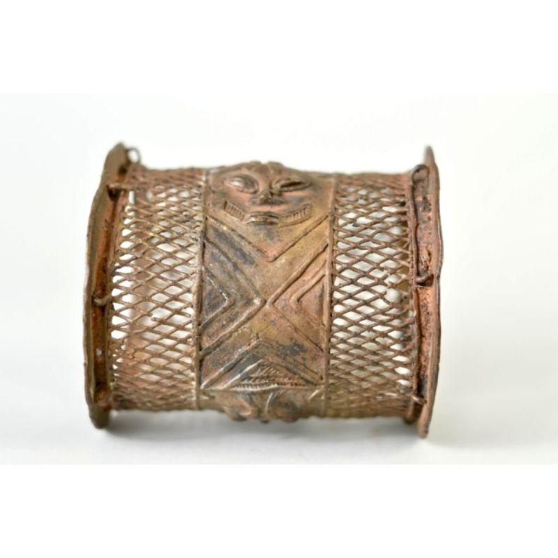 Ogboni Society Bracelet in Copper Alloy

A skillfully-executed copper alloy casting with delicate openwork flanking a central, vertically oriented human form, nineteenth c. or earlier. Ex private New York collection acquired between 1962 and 1975.