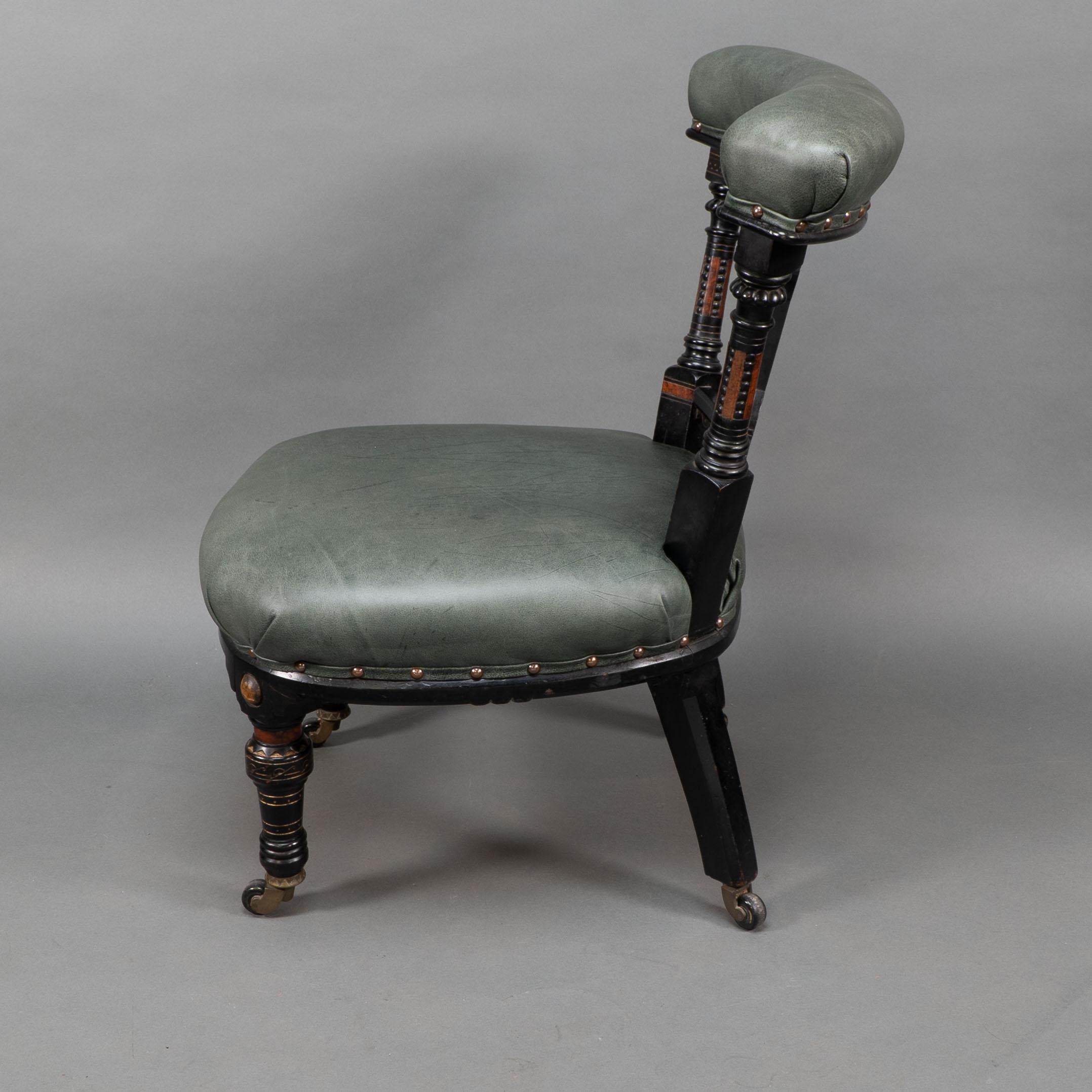 English Ogdens Of Manchester. An Aesthetic Movement Ebonized & Parcel Gilt Nursing Chair For Sale
