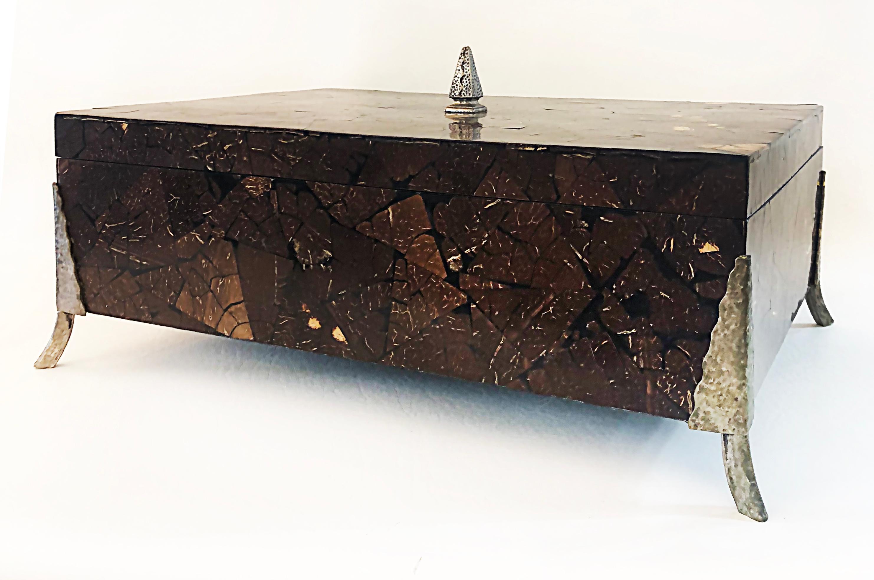Oggetti Tessellated Coconut Shell Lidded Box with Bronze Mounts, 1990s

Offered for sale is an elegant lidded box by Oggetti that is clad in tessellated crushed and polished coconut. The box is supported by bronze mount legs and is marked as made in