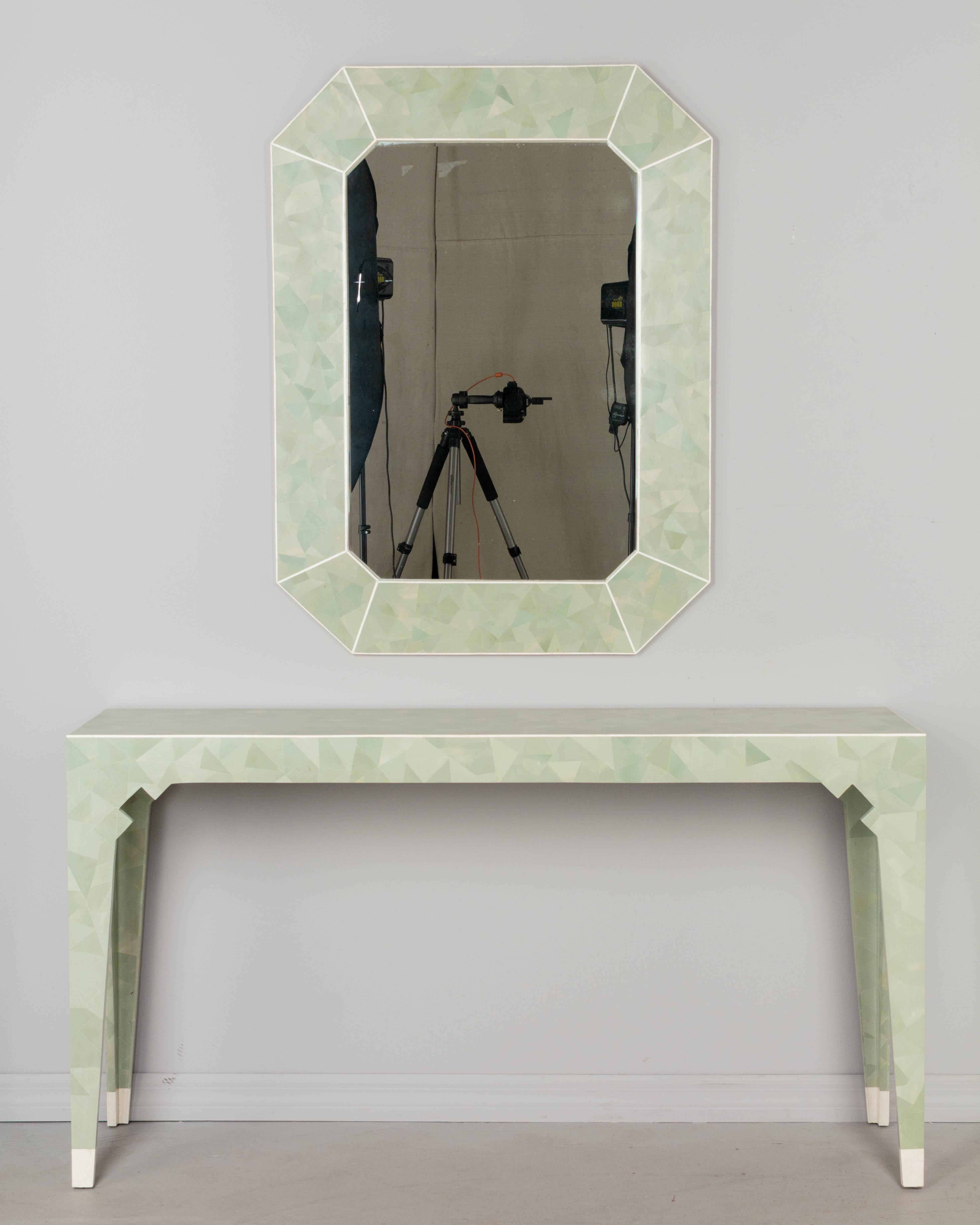 A Post Modern Italian tessellated stone wall mirror with matching narrow console table made by Oggetti. Beautiful matte finish seafoam green marble tiles, precisely cut and fitted in a triangular pattern with edges outlined in off-white marble. The