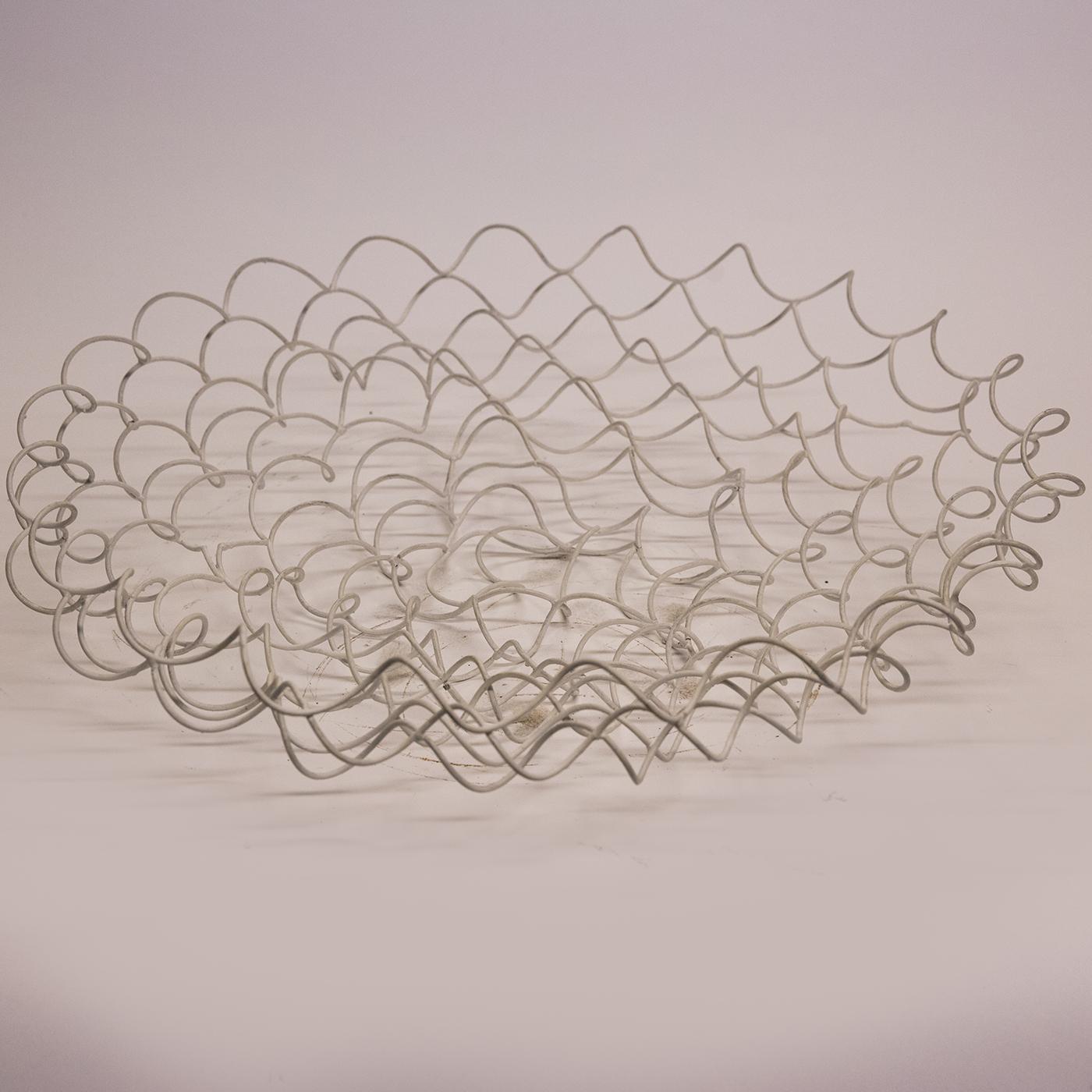 This sculptured vase by Sciortino is formed of spring-like tempered iron wire, forming an intriguing array of geometric shapes and shadows, and is finished with a coat of white paint applied by hand. Product dimensions may vary slightly due to the