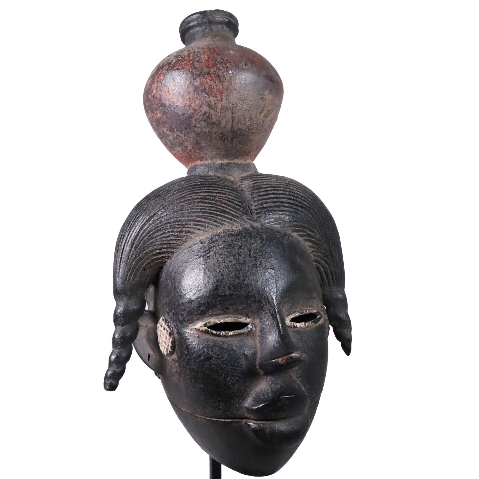 Mask with hinged jaw, Ogoni people, Southern Nigeria. Wood with black, white, and red-brown pigments. The lower jaw has inset slivers of wood for teeth (see photos). Created in the middle to late part of the 20th century.
Measures: 12 x 6 1/2 5