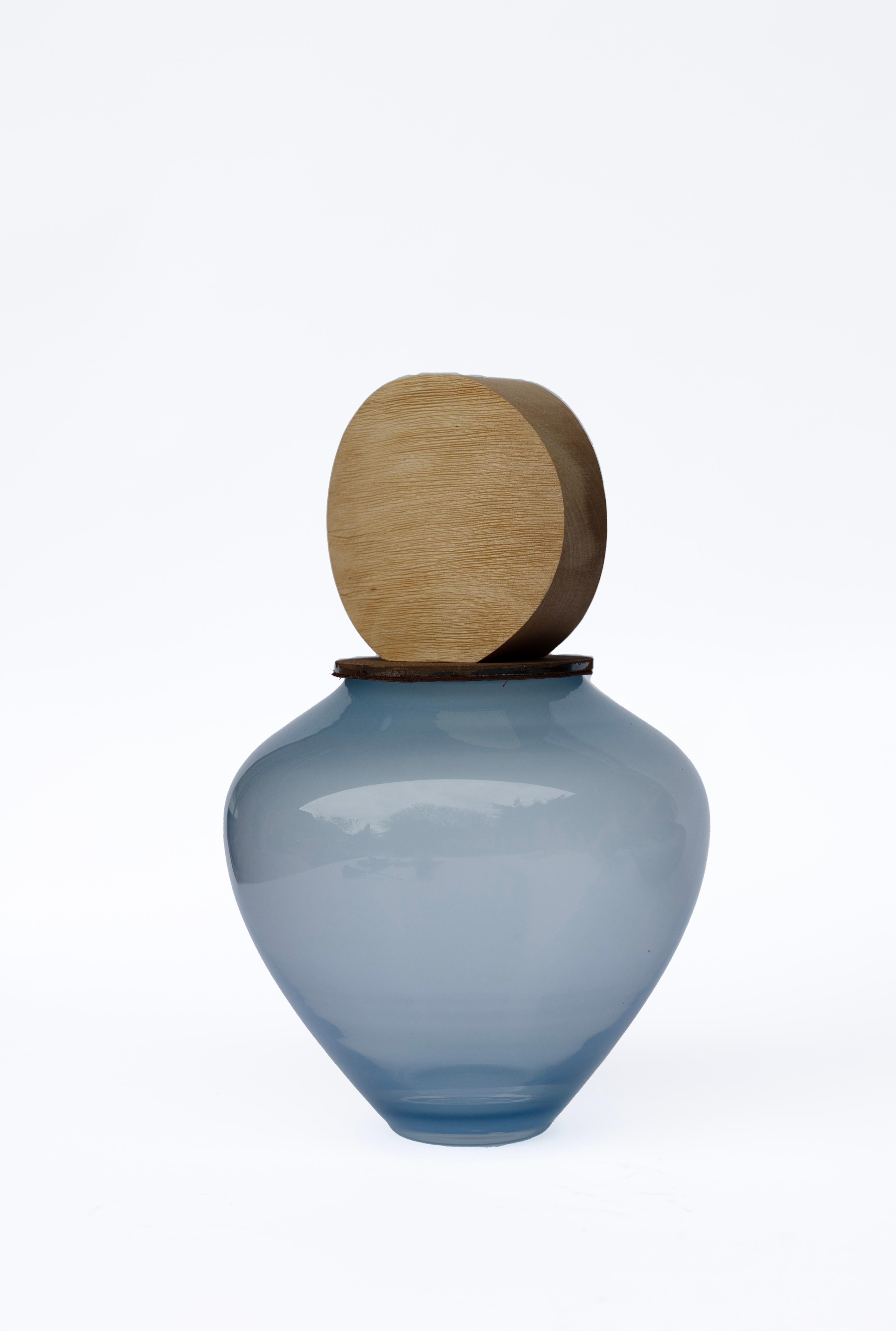 Ohana Stacking Pigeon Blue S & Round Vessel by Pia Wüstenberg
Unique Piece. Handmade In Europe.
Dimensions: Ø 19 x H 25 cm.
Materials: Handblown glass, ceramic and wood.

Available in different color options. Dimensions are approximate, due to the