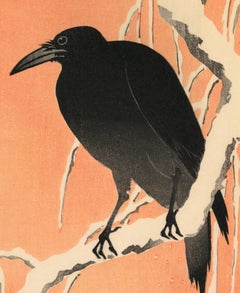 Crow on a Snowy Willow Branch with Orange Sky