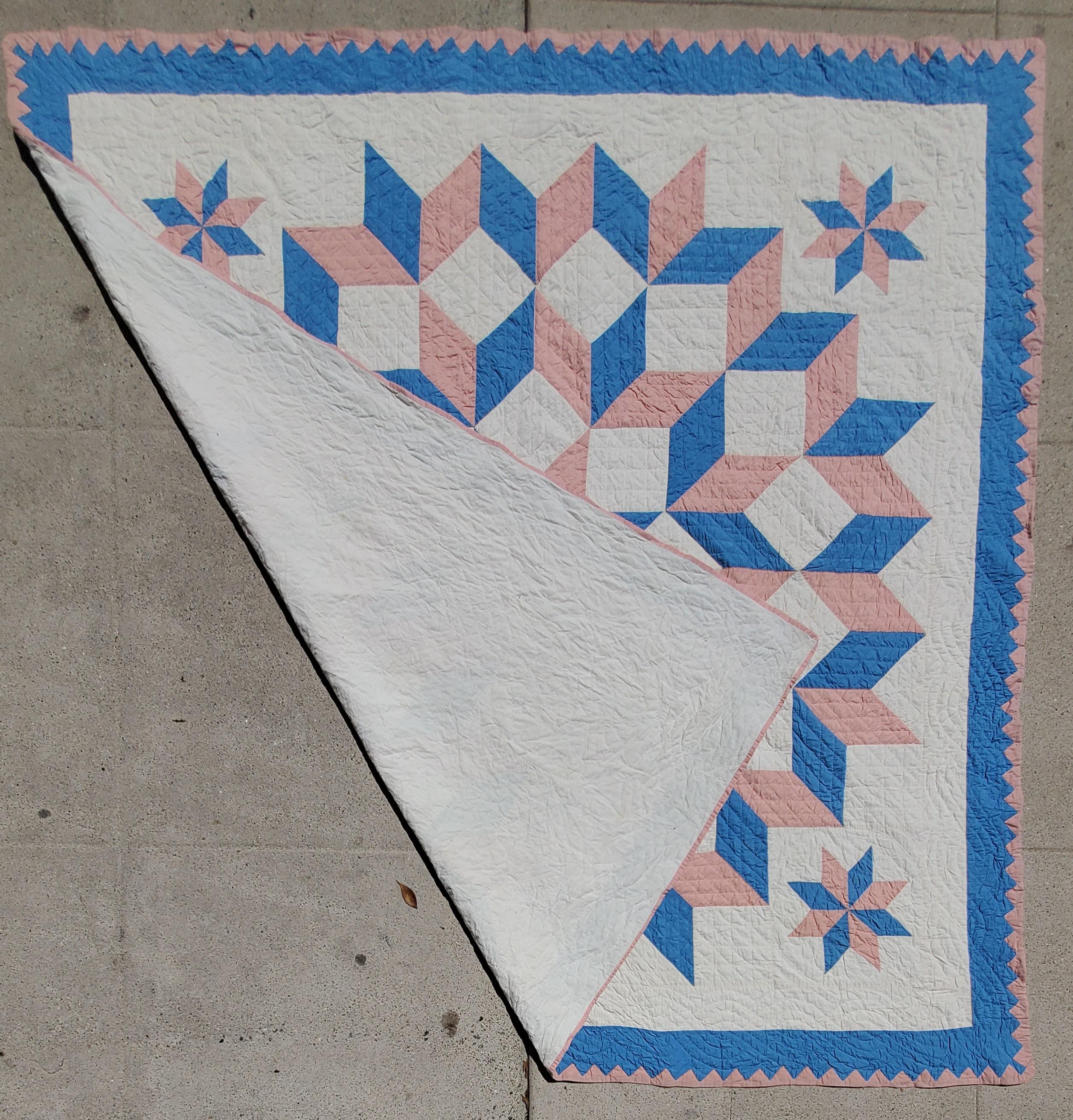 Ohio Amish blue & pink broken star quilt in pristine condition. Very fine quilting and piece work. Notice the fine hand stitched saw tooth binding.