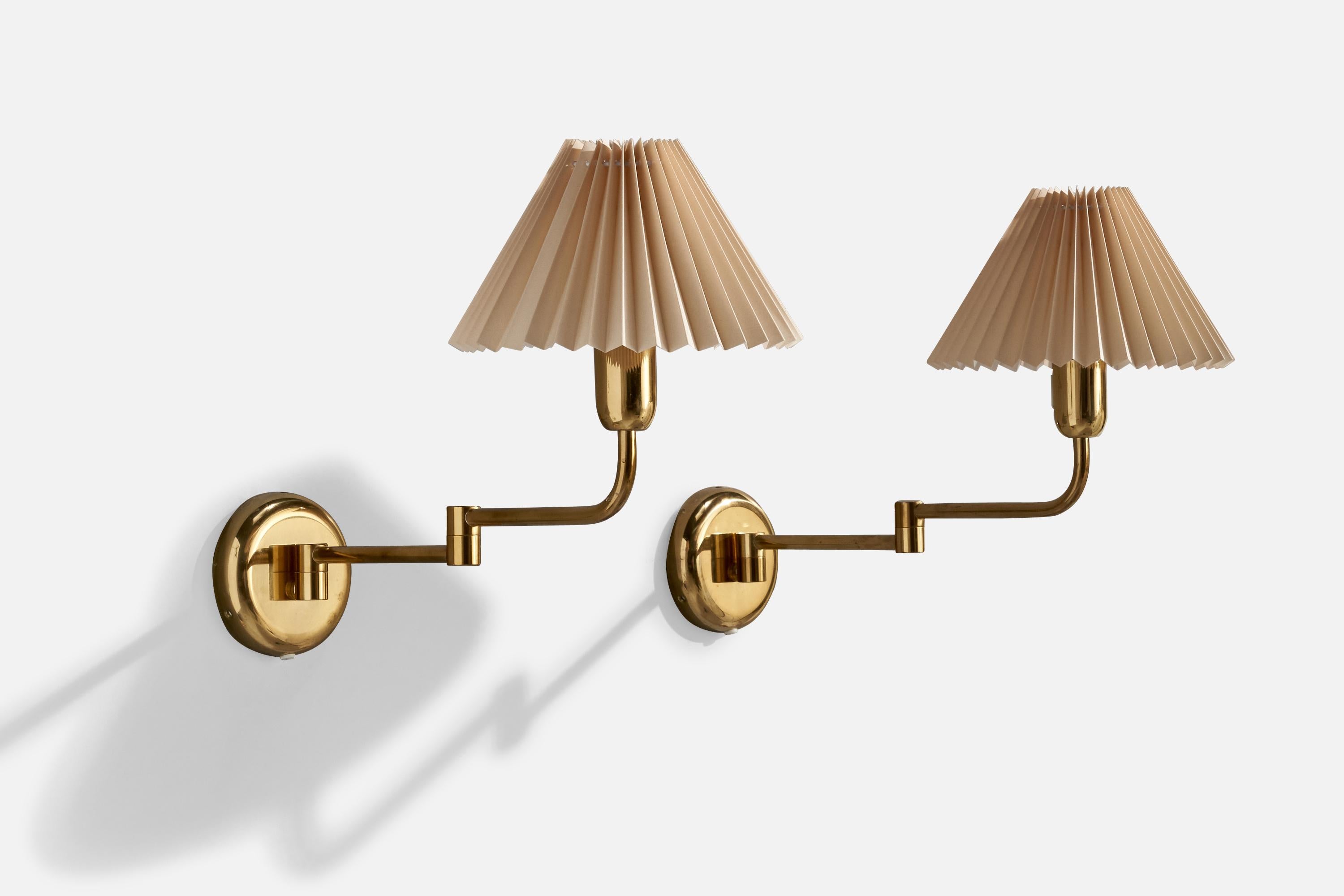 A pair of brass and paper wall lights produced by ÖIA, Sweden, c. 1970s.

Overall Dimensions (inches):  14” H x 10” W x 20.375“ D

Back Plate Dimensions (Inches): 5 ” H x 5” W x 1 ” D

Bulb Specifications: E-26

Number of Sockets (per fixture):