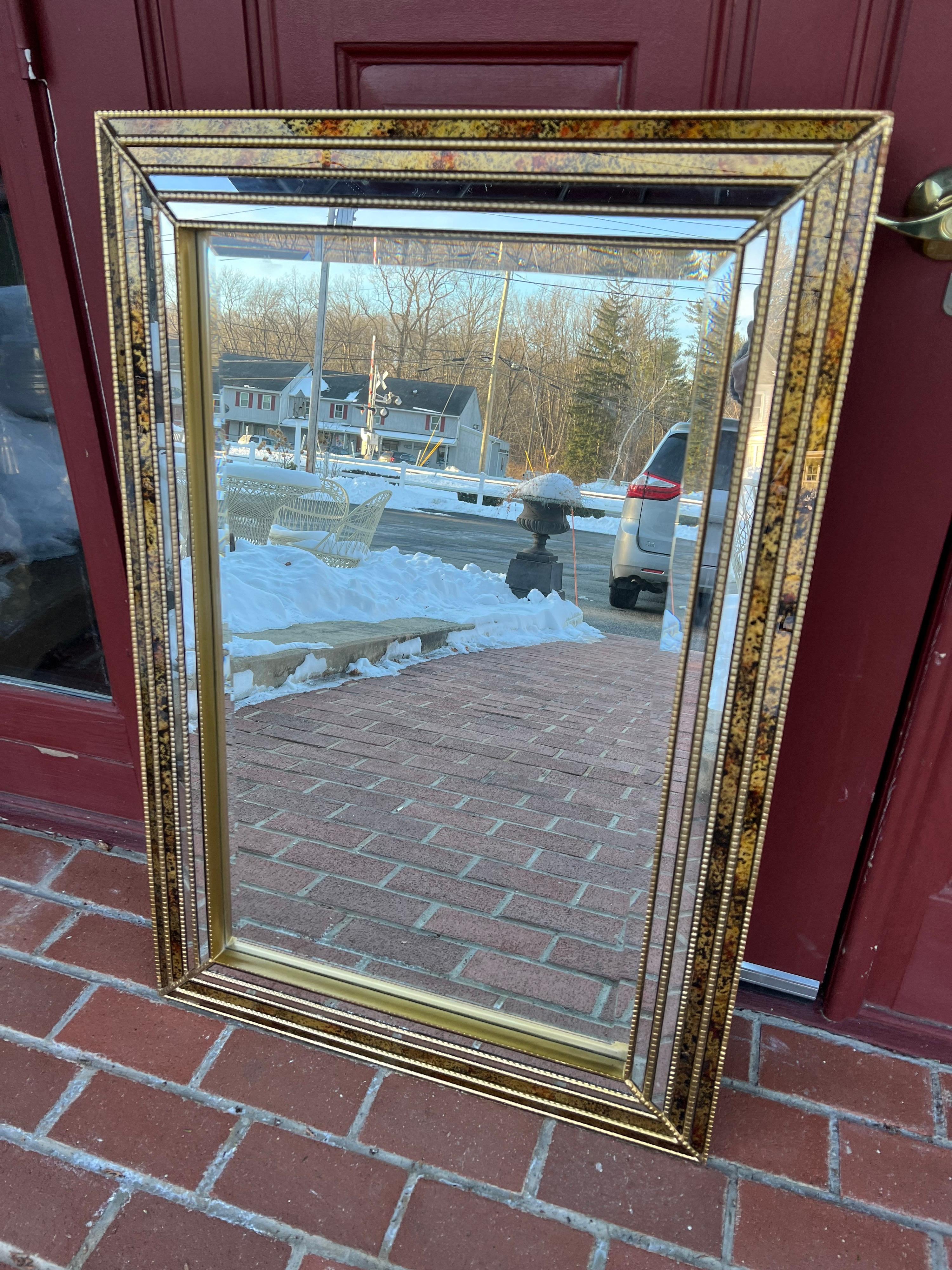 Oil Drip Beveled Mirror Attributed to LaBarge. Rectangular beveled mirror with beaded brass frame and oil drip inlaid decoration reminiscent of tortoiseshell. Very good condition.